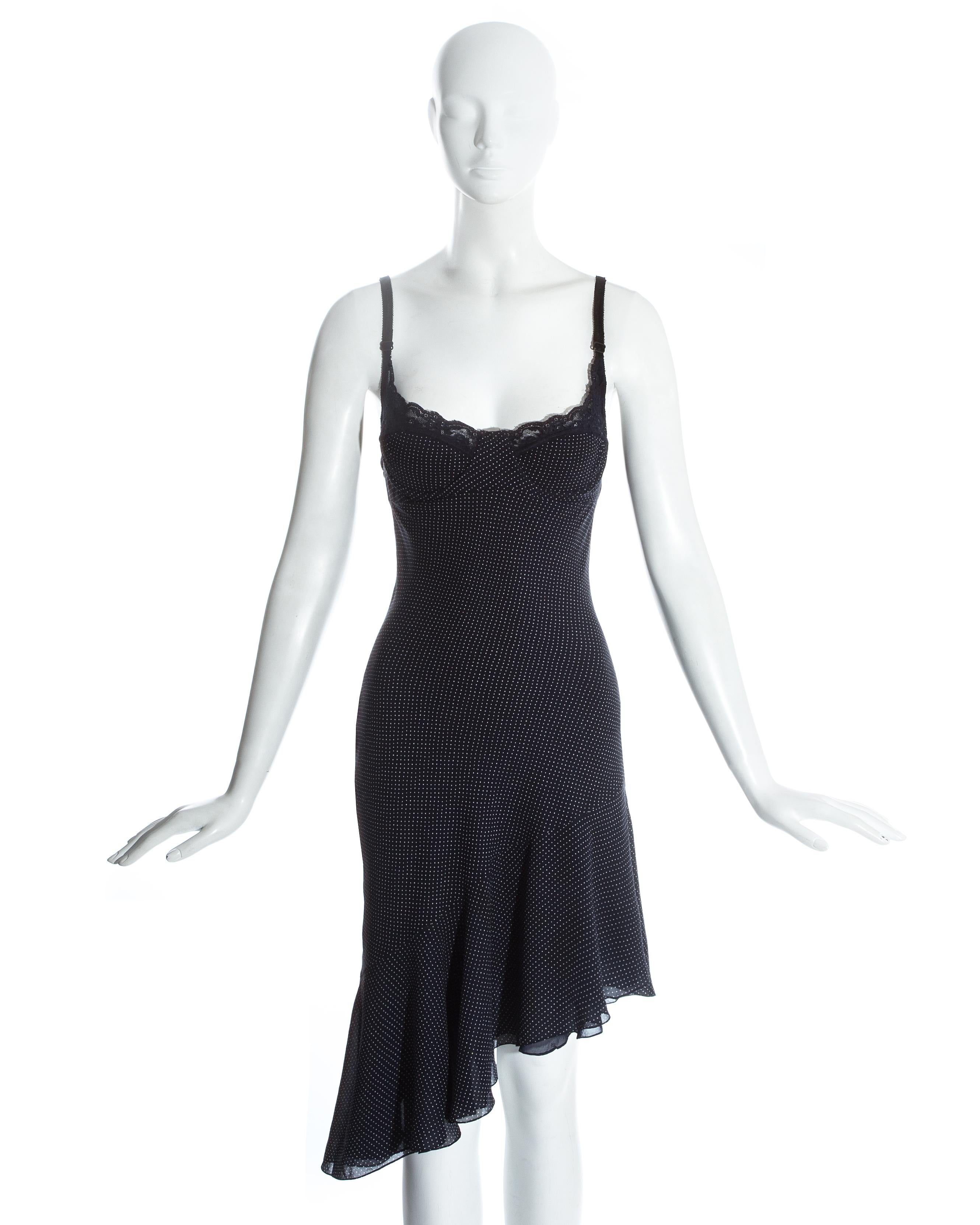 John Galliano; Navy blue polka dot print silk bias cut slip dress. Built in lace bra with adjustable spaghetti straps and underband, asymmetric flounce hem and low open back. 

Spring-Summer 1997