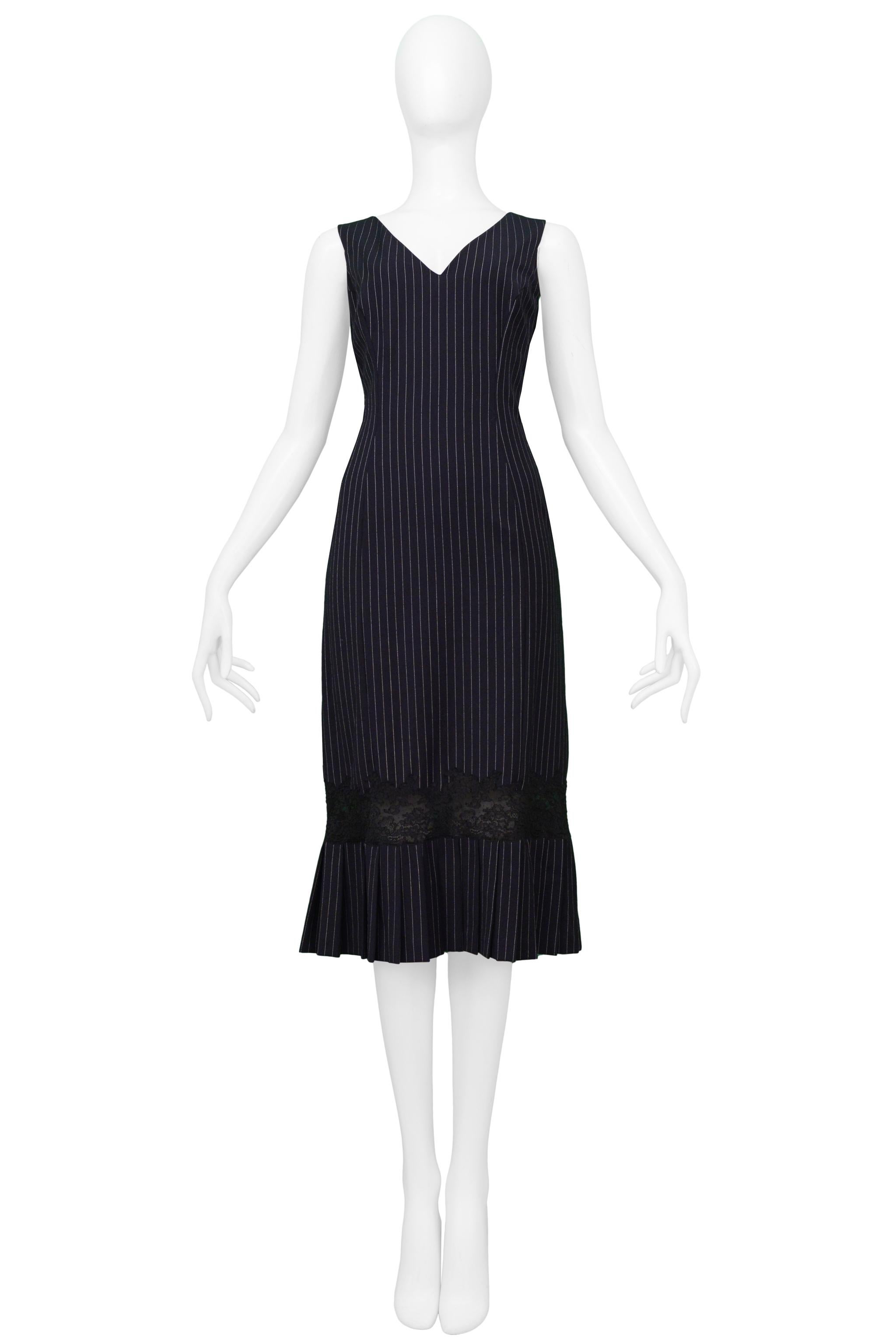 Resurrection is excited to offer a vintage John Galliano navy blue wool dress with pinstripes featuring a V front and back neckline, sleeveless, and pleated hem with lace detail.

John Galliano
Size 42
Wool and Lace 
Excellent Vintage