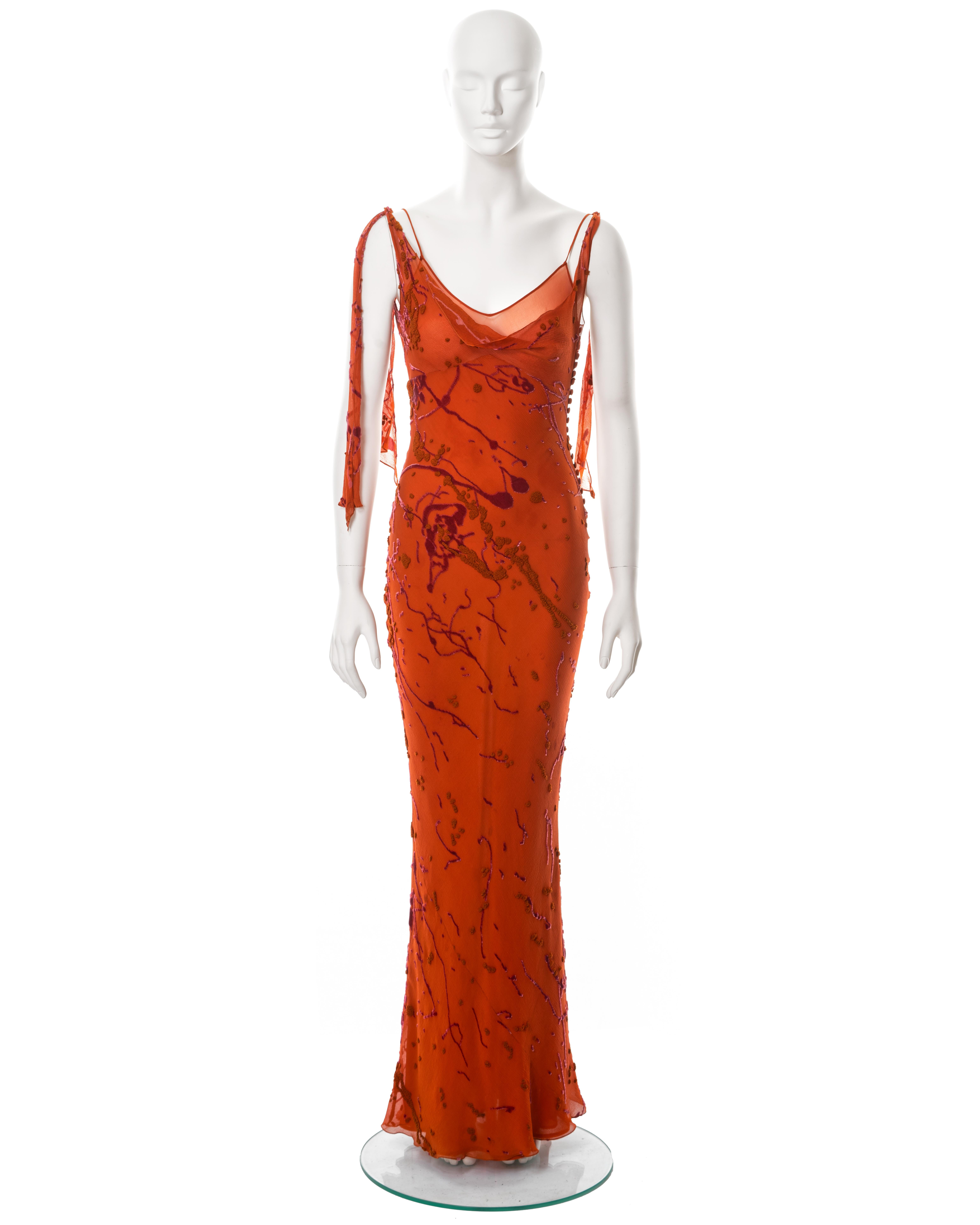 ▪ John Galliano evening dress
▪ Sold by One of a Kind Archive
▪ Fall-Winter 2000
▪ Constructed from orange bias-cut crinkled silk devoré 
▪ Velvet and French-knot embroidery paint splatter motifs
▪ Silk chiffon underdress 
▪ Cowl neck
▪ 3 Ties knot
