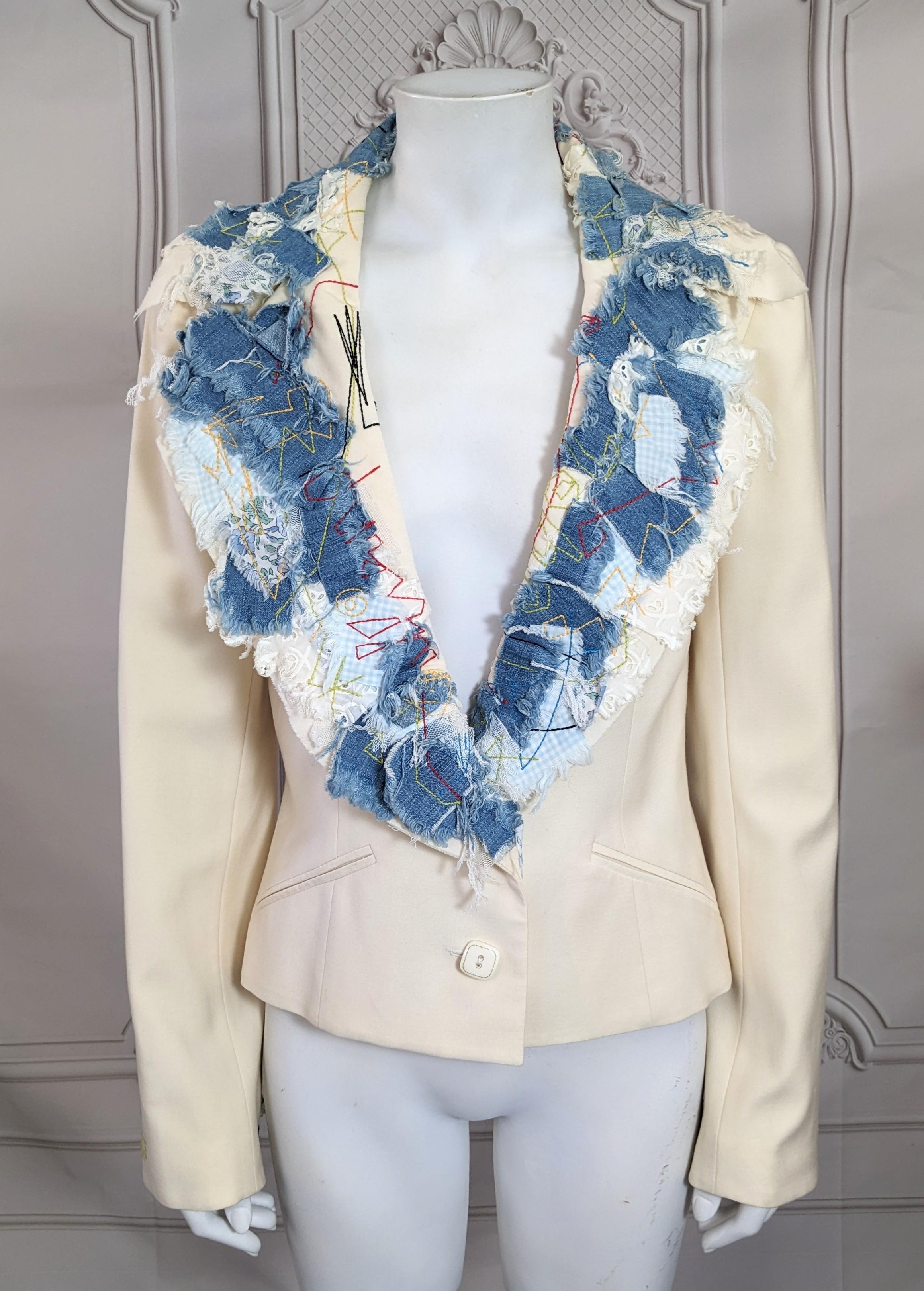 Amazing John Galliano 2002 pre collection patchwork and applique blazer. The classicly tailored nipped ivory short jacket with appliques based on scrapbooking and patchworking. Swatches of blue denim, gingham and tulle fabrics stitched onto the