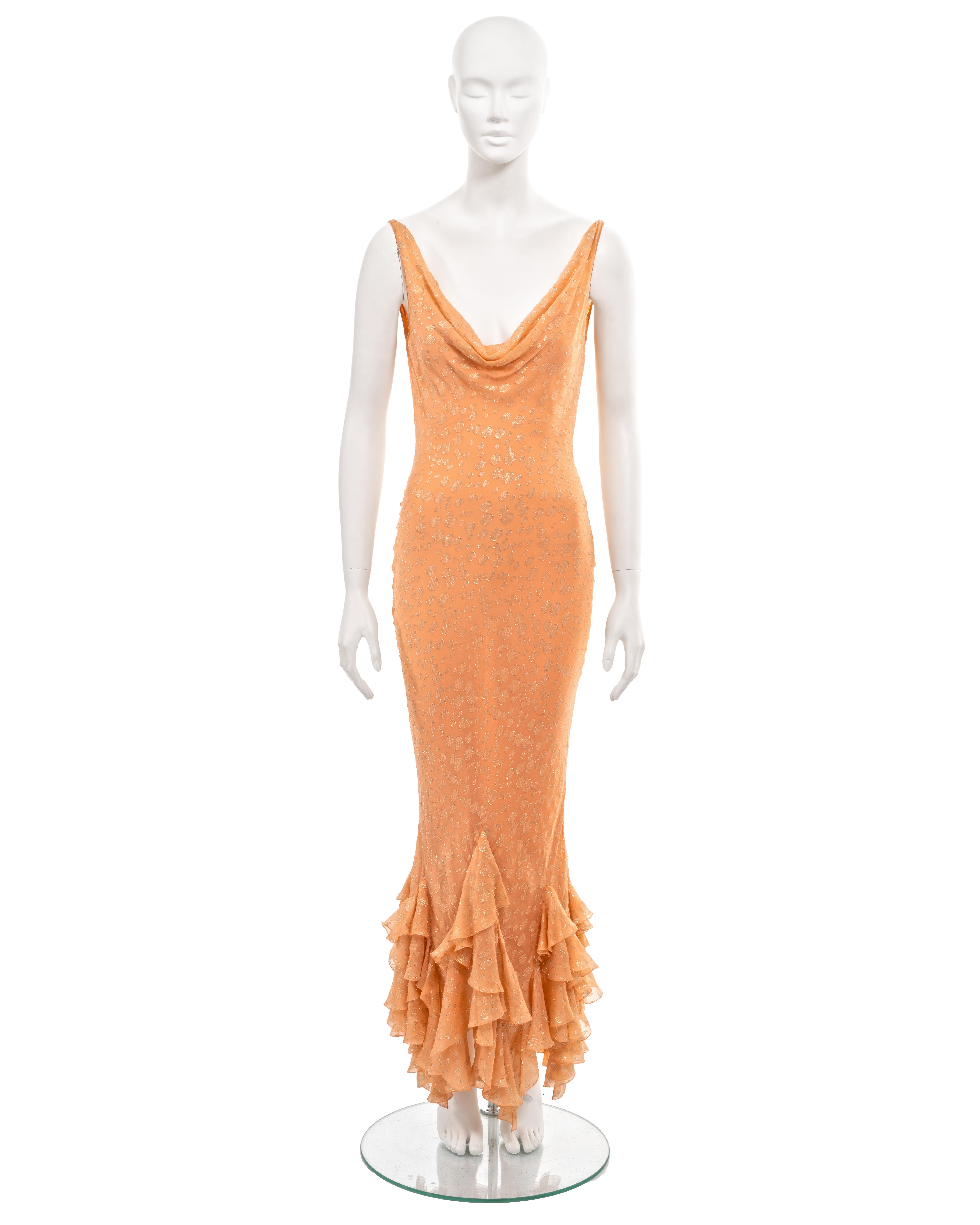 ▪ John Galliano evening dress
▪ Sold by One of a Kind Archive
▪ Spring-Summer 2004
▪ Peach silk chiffon with allover woven gold lurex spotted motif 
▪ Plunging cowls to the front and back necklines 
▪ Floor-length skirt with tiered ruffled hem 
▪