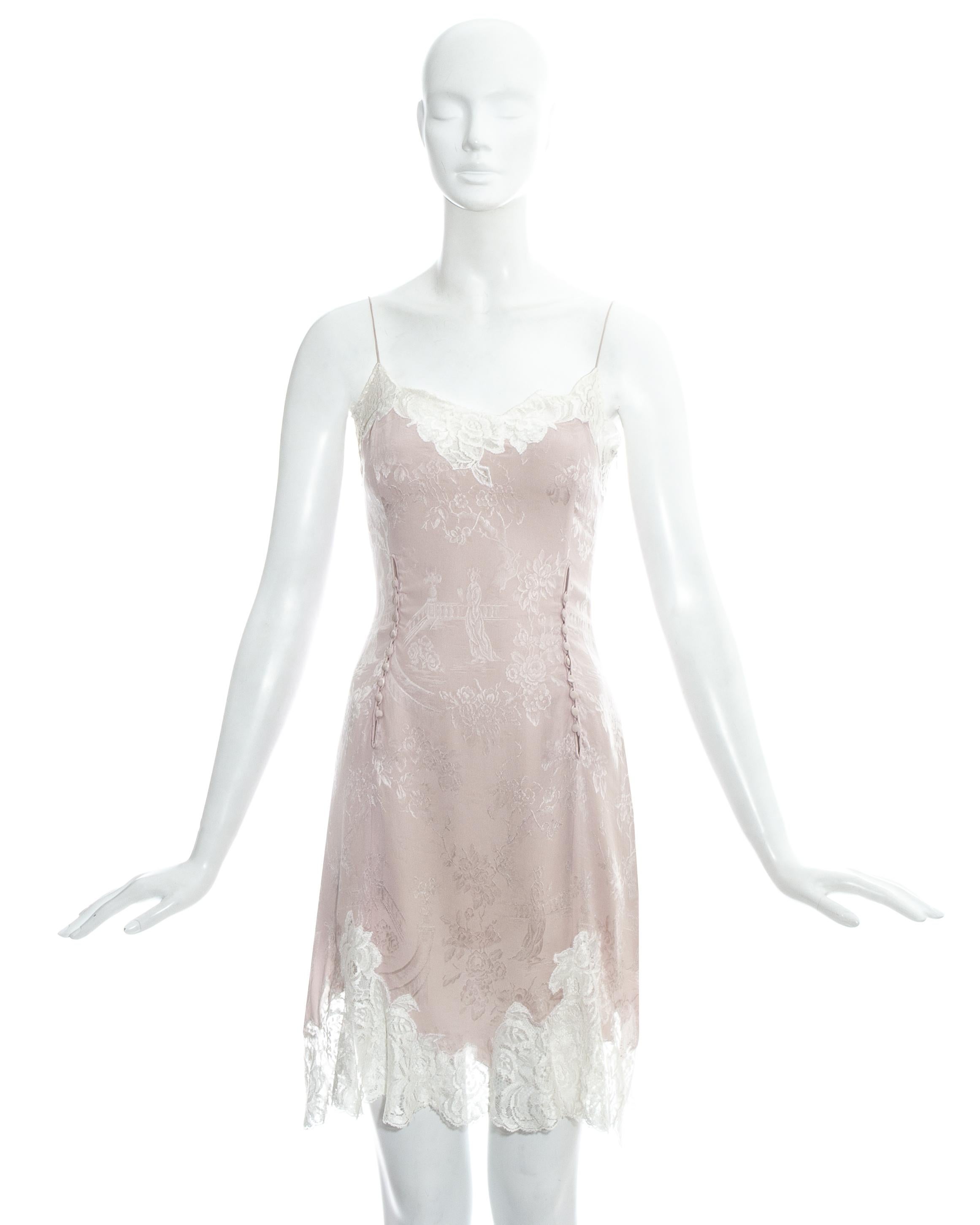 John Galliano; pink silk brocade evening slip dress with white lace trim, four openings on the waist - fastening with matching silk buttons and zip closure on side seam. 

Spring-Summer 1998

Bust: 34
