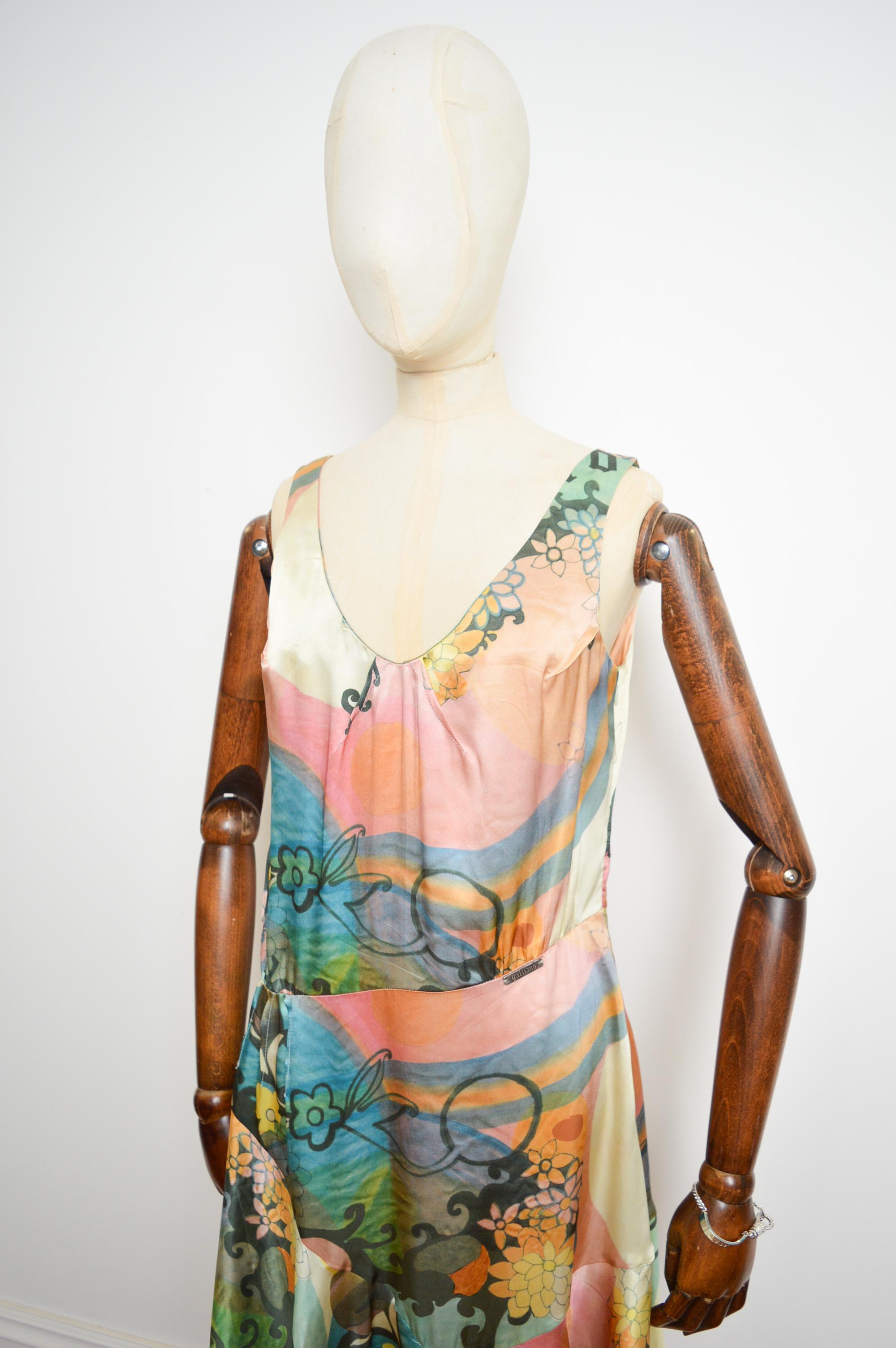 Delicate pastel coloured pure silk 'John Galliano' abstract floral patterned dress, cut in a typical 1920's 'Garçonne' style with a gliding asymmetrical drop waist.

MADE IN ITALY.   

Measurements are provided in Inches:  
Pit to Pit; 18.5