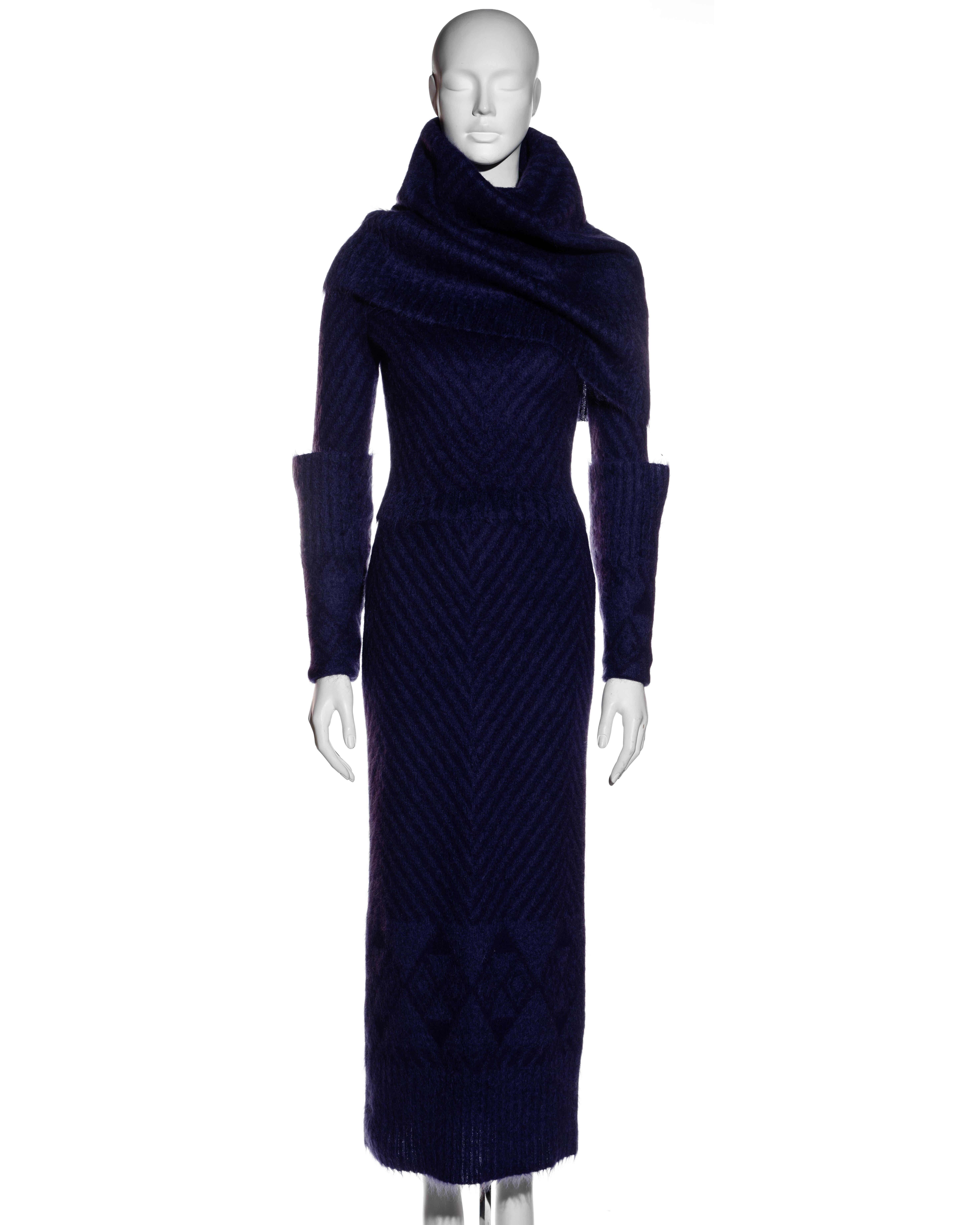 ▪ John Galliano purple mohair sweater and skirt set
▪ Black herringbone design with purple base 
▪ Turn-over cuffs 
▪ Large high-neck fold-over collar 
▪ Ankle-length skirt 
▪ 40% Mohair, 32% Wool, 18% Nylon, 10% Angora 
▪ Size Small
▪ Fall-Winter