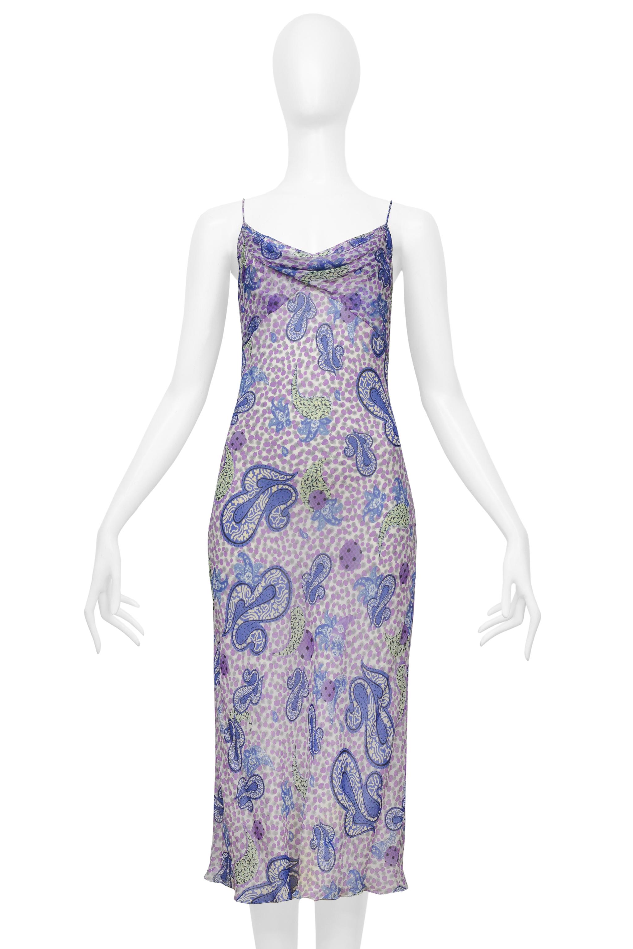 Resurrection Vintage is thrilled to present a vintage John Galliano purple and blue dress made of sheer silk chiffon, highlighted by a beautiful paisley pattern, a draped neckline, a classic slip dress silhouette, and delicate skinny straps. 

John