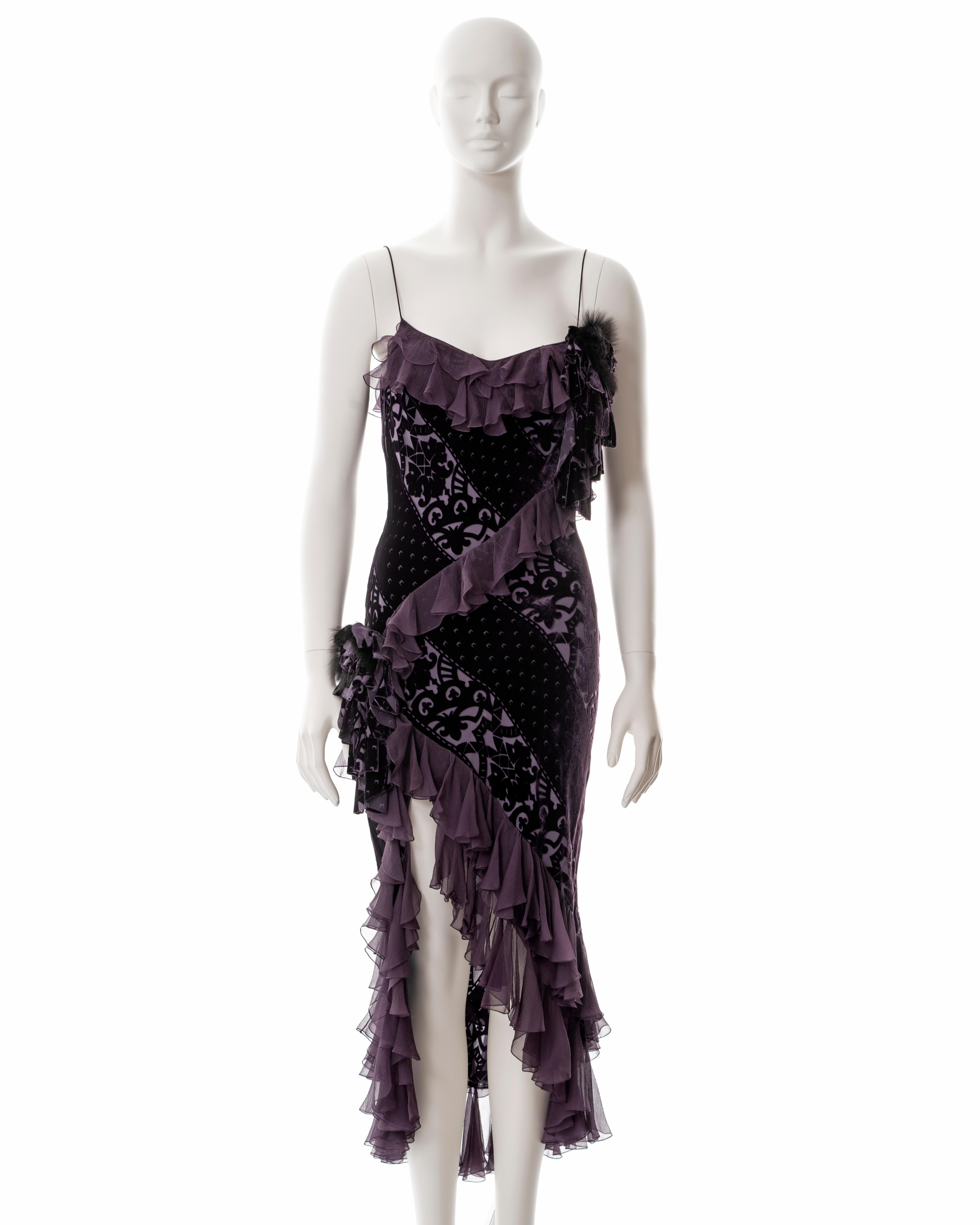 ▪ John Galliano purple velvet devoré and silk bias cut evening dress
▪ Sold by One of a Kind Archive
▪ Fall-Winter 2003 
▪ High leg slit 
▪ Ruffled silk trim and skirt 
▪ Floral corsages with fur 
▪ FR 38 - UK 10 - US 4
▪ Made in France

All