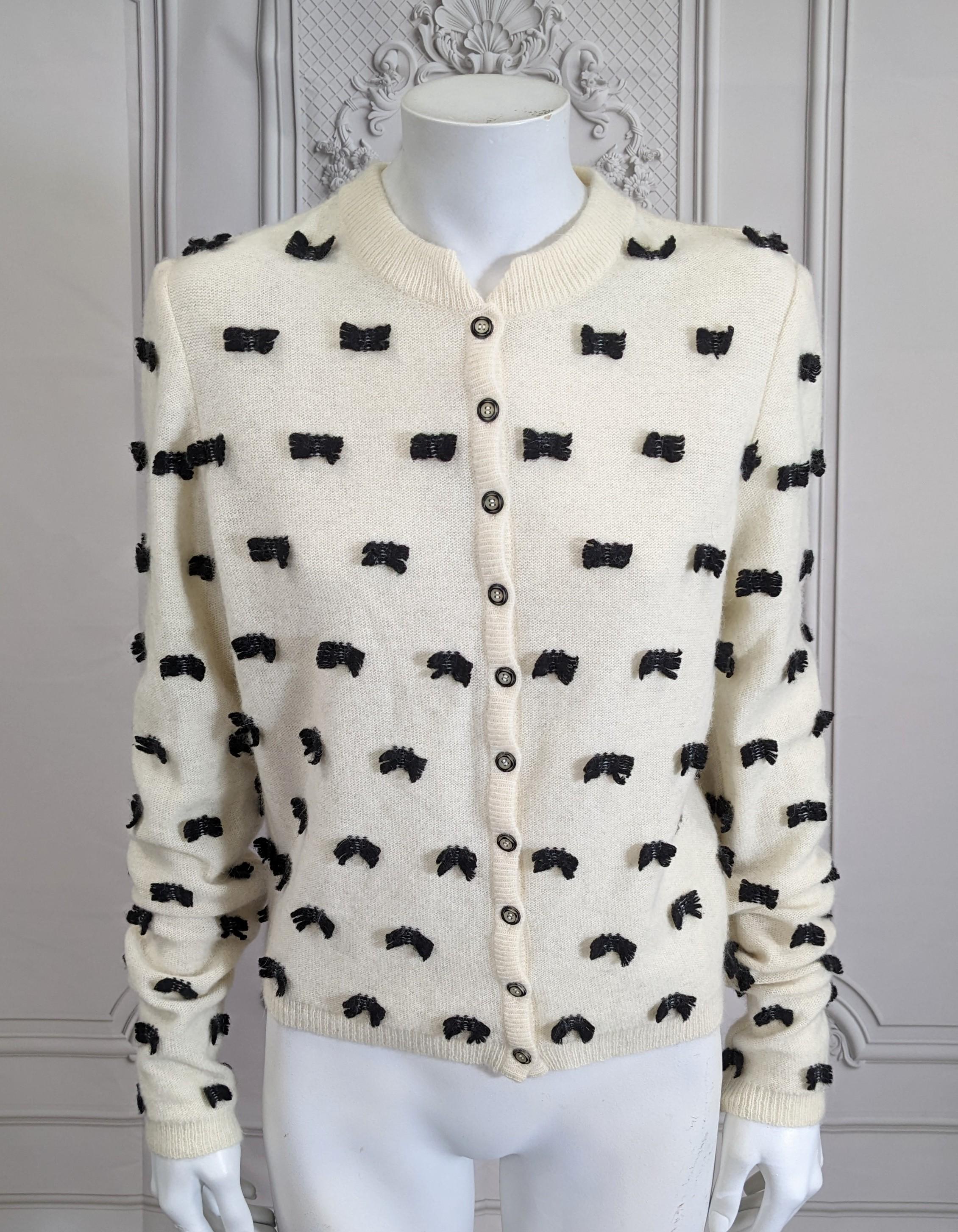 John Galliano  Spring/Summer 1998 -99 ladylike ivory and black wool blend long sleeve cardigan sweater. The cardigans ivory ground overall embellished with small black wool bows.
Excellent Condition, Size Medium, Made in Italy.