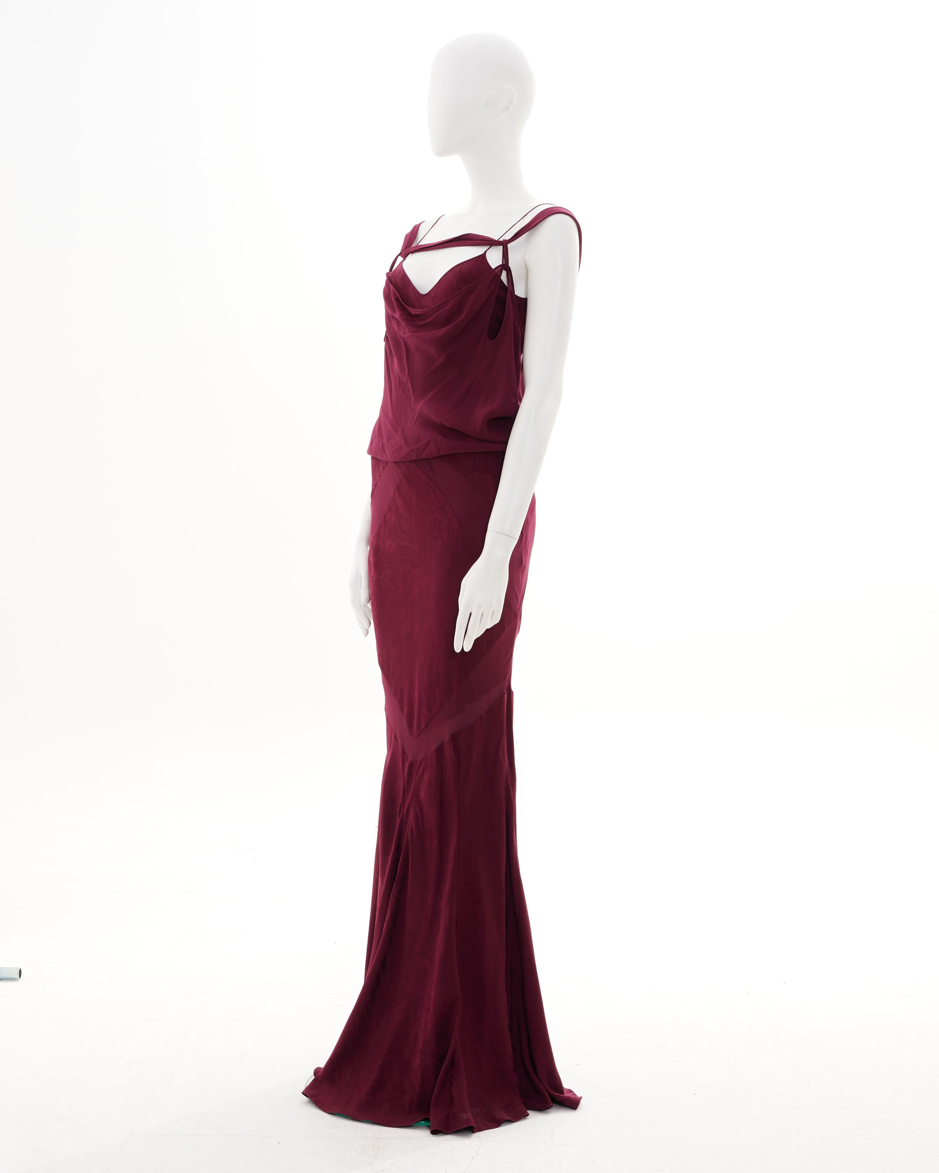 - Designed by John Galliano 
- Sold by Skof.Archive
- Spring-Summer 2009 
- Bordeaux bias-cut silk evening dress with train
- Bodice with v-neck and spaghetti straps and draped cowl overlay with twisted off-shoulder straps
- Red crepe-backed satin