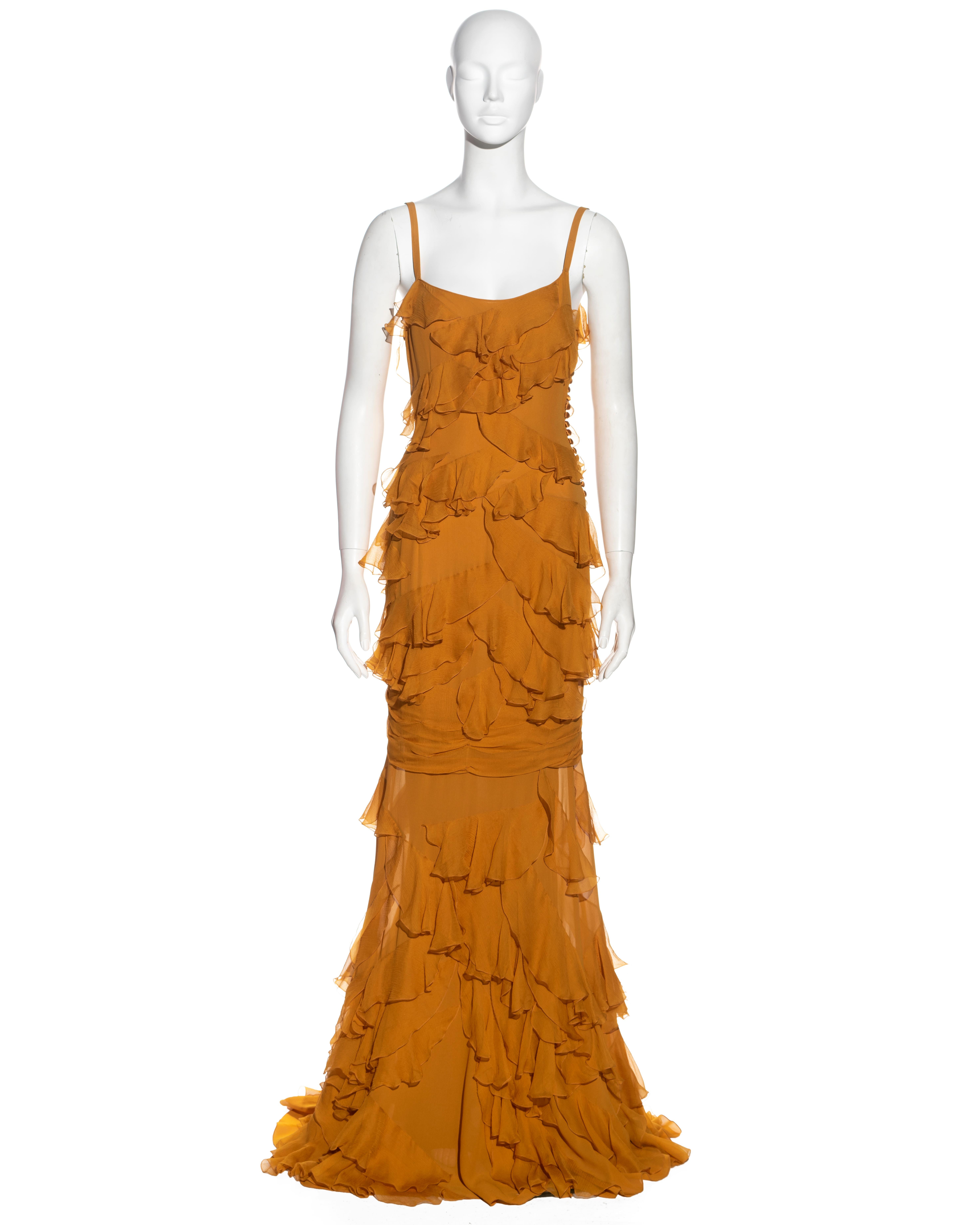 ▪ John Galliano evening dress
▪ Sold by One of a Kind Archive
▪ Constructed from saffron silk chiffon 
▪ Ruffled bias-cut trims 
▪ Floor-length skirt with train 
▪ Multiple decorative fabric buttons on the side seam
▪ FR 38 - UK 10 - US 6
▪
