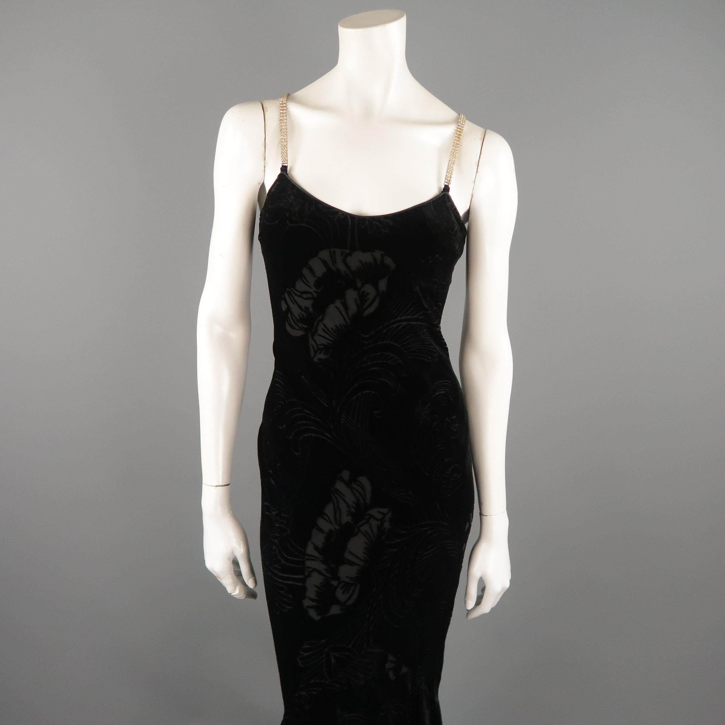 Archive JOHN GALLIANO gown comes in black floral print burnout velvet with a strapless V neck, clear silver rhinestone straps, and fitted silhouette with flaired train. Missing one rhinestone shown in detail shot. Made in France.
 
Very Good