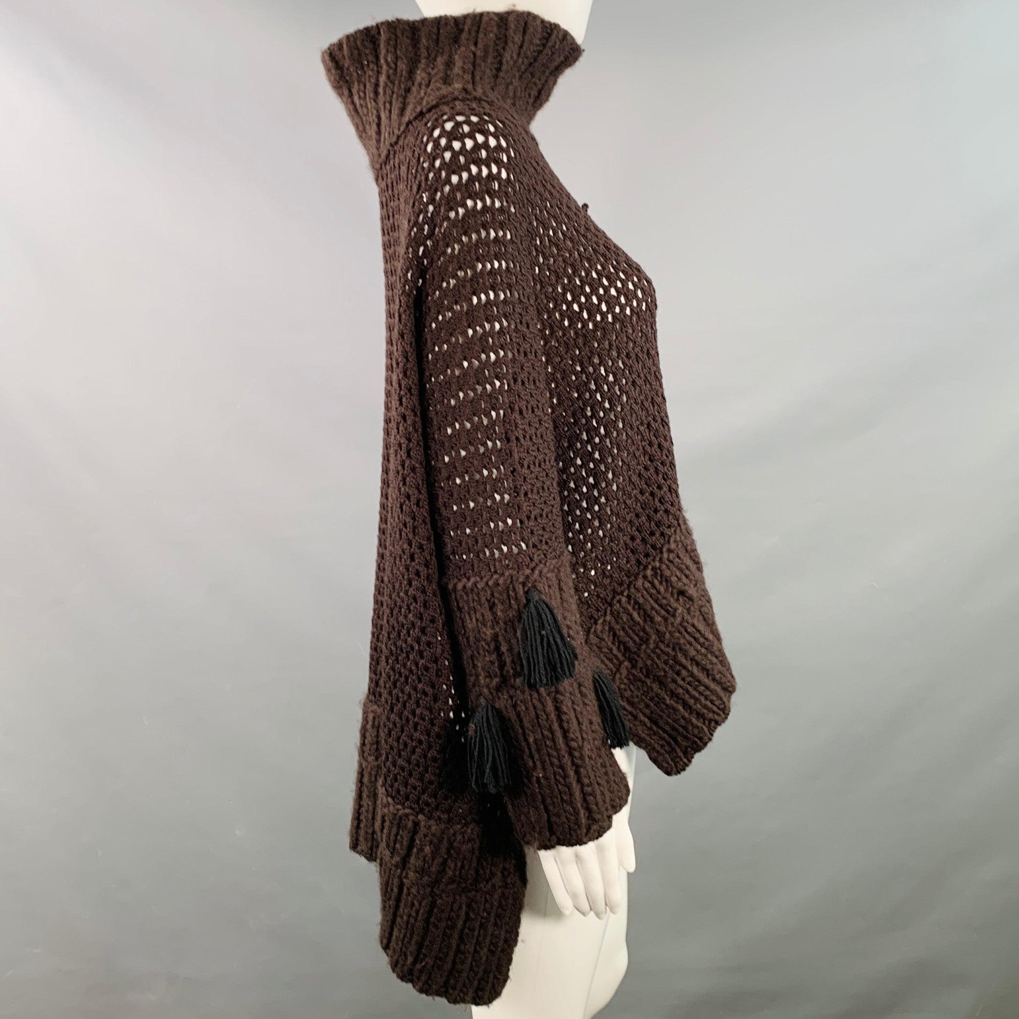 JOHN GALLIANO sweater
in a brown wool blend knit featuring a chunky knit style, long sleeves with black tassel details, and turtleneck. Made in Italy.Good Pre-Owned Condition. Moderate pilling. 

Marked:   M 

Measurements: 
 
Shoulder: 17.5 inches