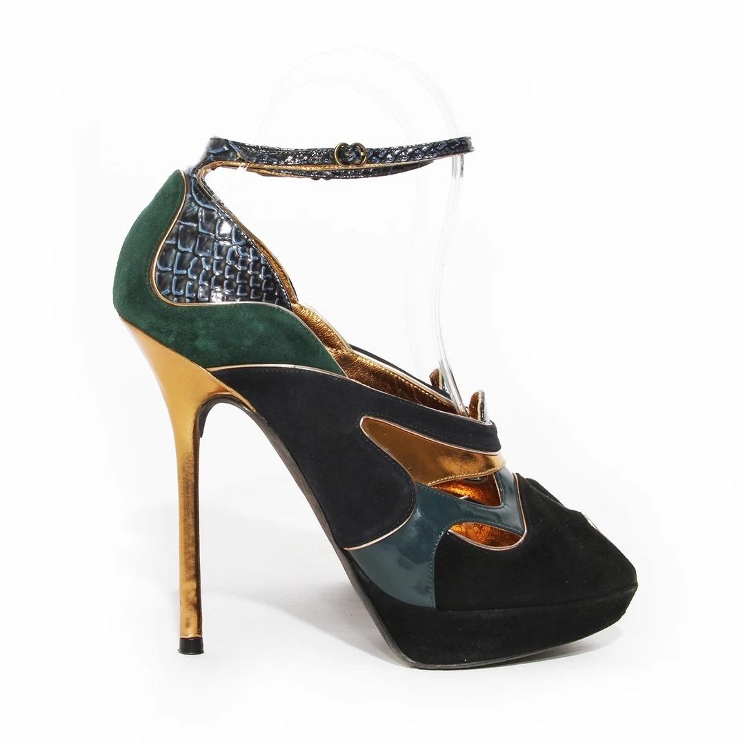 John Galliano Heels  
Made in Italy
Green, Gold, Navy Blue and Black
Suede intermixed with patent wine
Snakeskin print details on heel and ankle strap
Ankle strap
Peep toe 
Gold heel 
Gold piping details 
Platform 
Good condition; Preloved with some