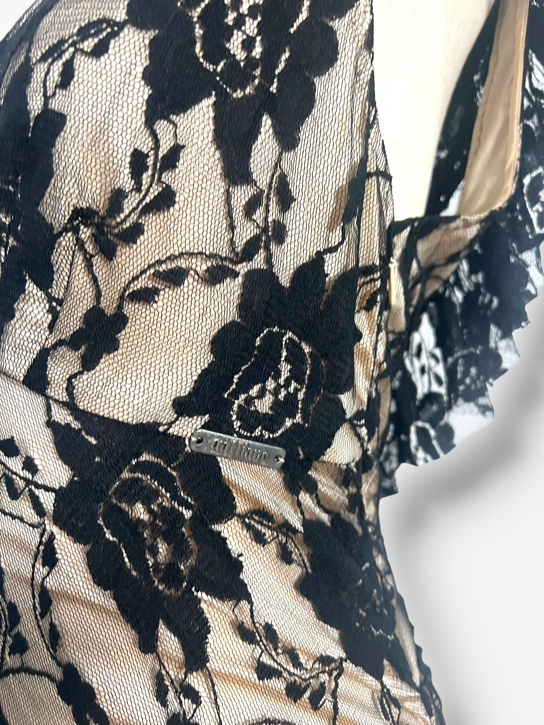 breathtaking example of John Galliano’s romantic design language, this 2010s-era gown from his namesake label is cut entirely on the bias from delicate black lace layered over a nude stretch base. The result is a sculpted, fluid silhouette that