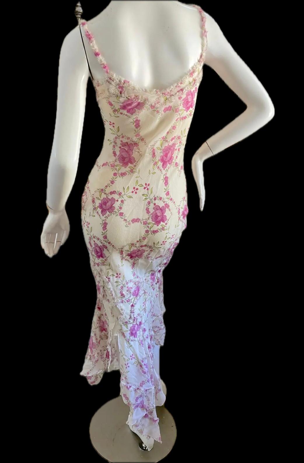 Romantic and timeless, this floral Spring 2004 John Galliano dress is a silk vision. Its iconic pattern, with rosebud hearts and ruffled frills, graced several looks on the Spring 2004 runway. Cut on a bias, this French size 38 will accommodate a