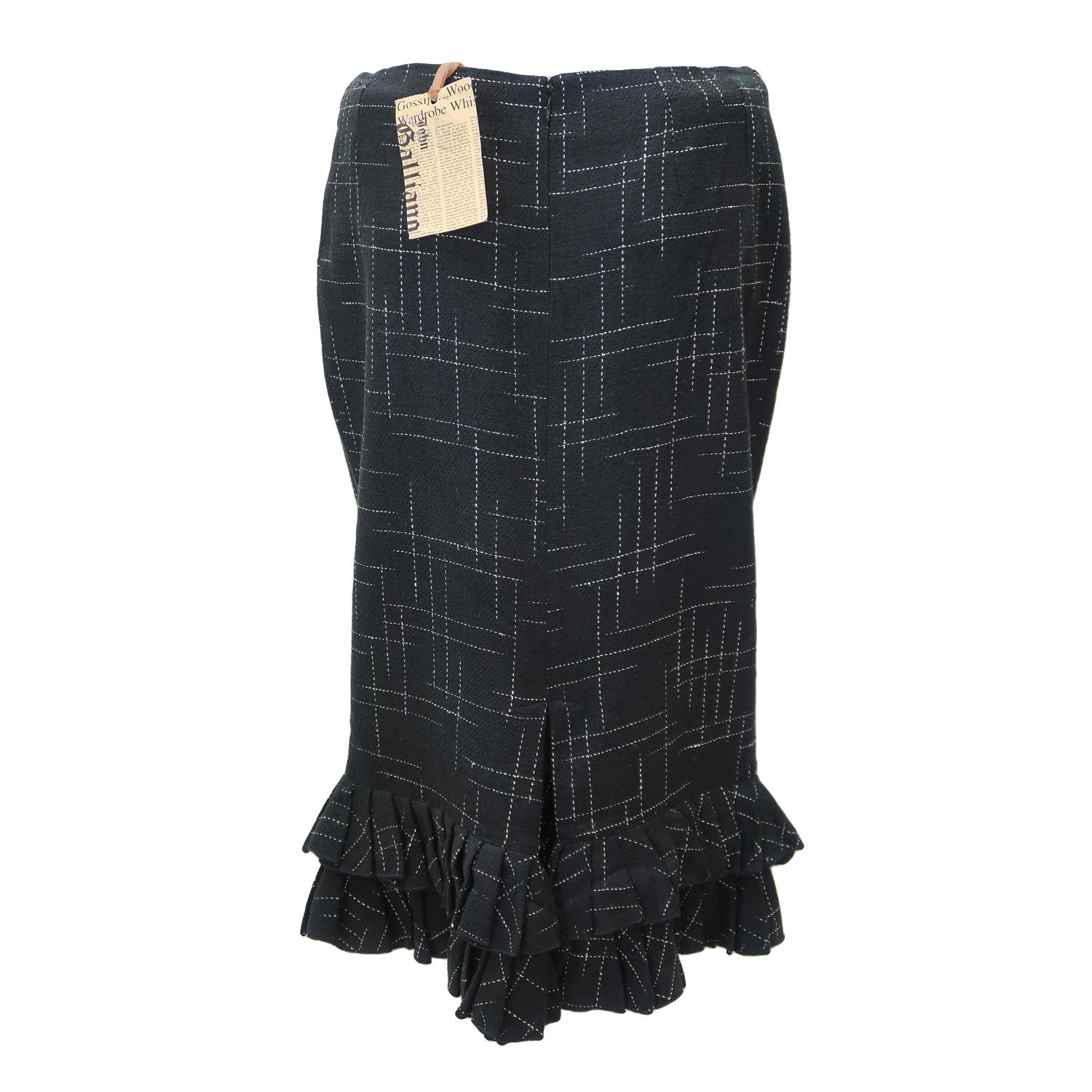The genius of John Galliano was his ability to make even the most traditional shapes alluring and seductive, adding his own personal twist to classical dressing. This stylish knee length silk stripe motif skirt seems prim and proper, but its flirty
