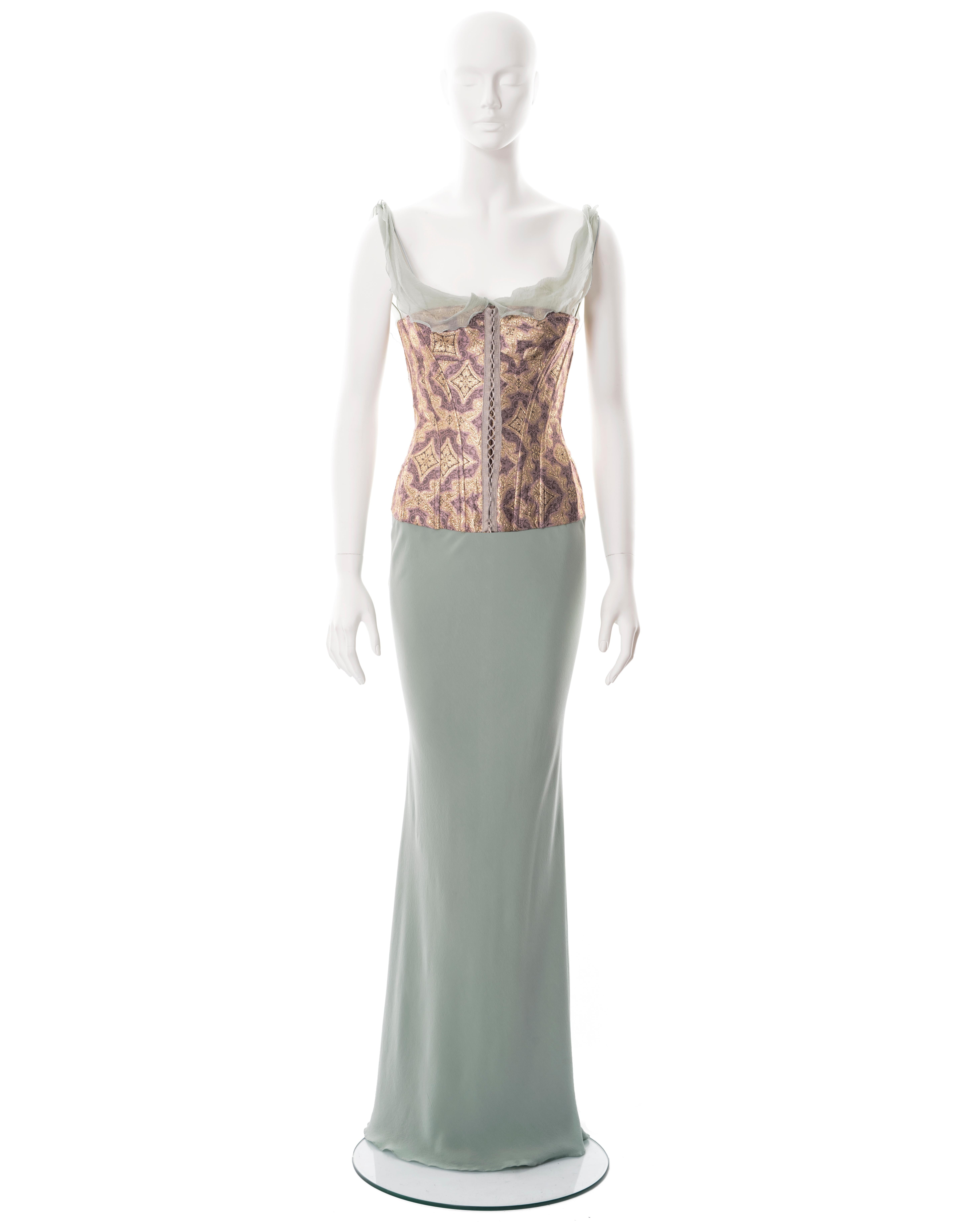 ▪ John Galliano evening dress
▪ Sold by One of a Kind Archive
▪ Spring-Summer 2003
▪ Constructed from pale teal bias-cut silk 
▪ Integrated corset of metallic gold and lavender brocade 
▪ Lace-up fastening 
▪ Draped chiffon cowl and shoulder straps