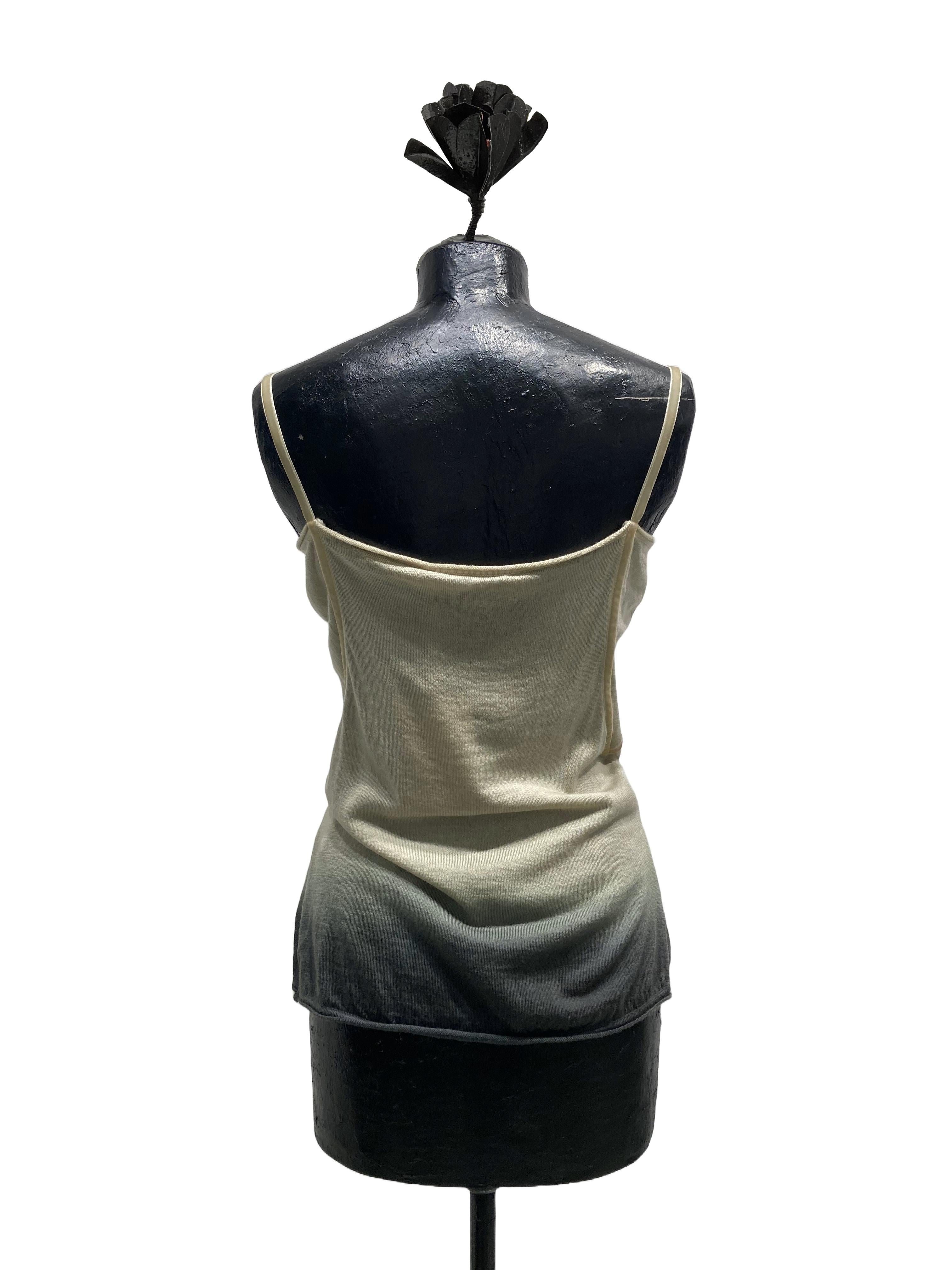 John Galliano's degradé wool knit top from the collection
Ready to Wear Fall Winter 2006. The top is decorated at the front with pleats fixed diagonally by a
velvet ribbon that, reaching to the center of the neckline, ends in a bow.
The same velvet