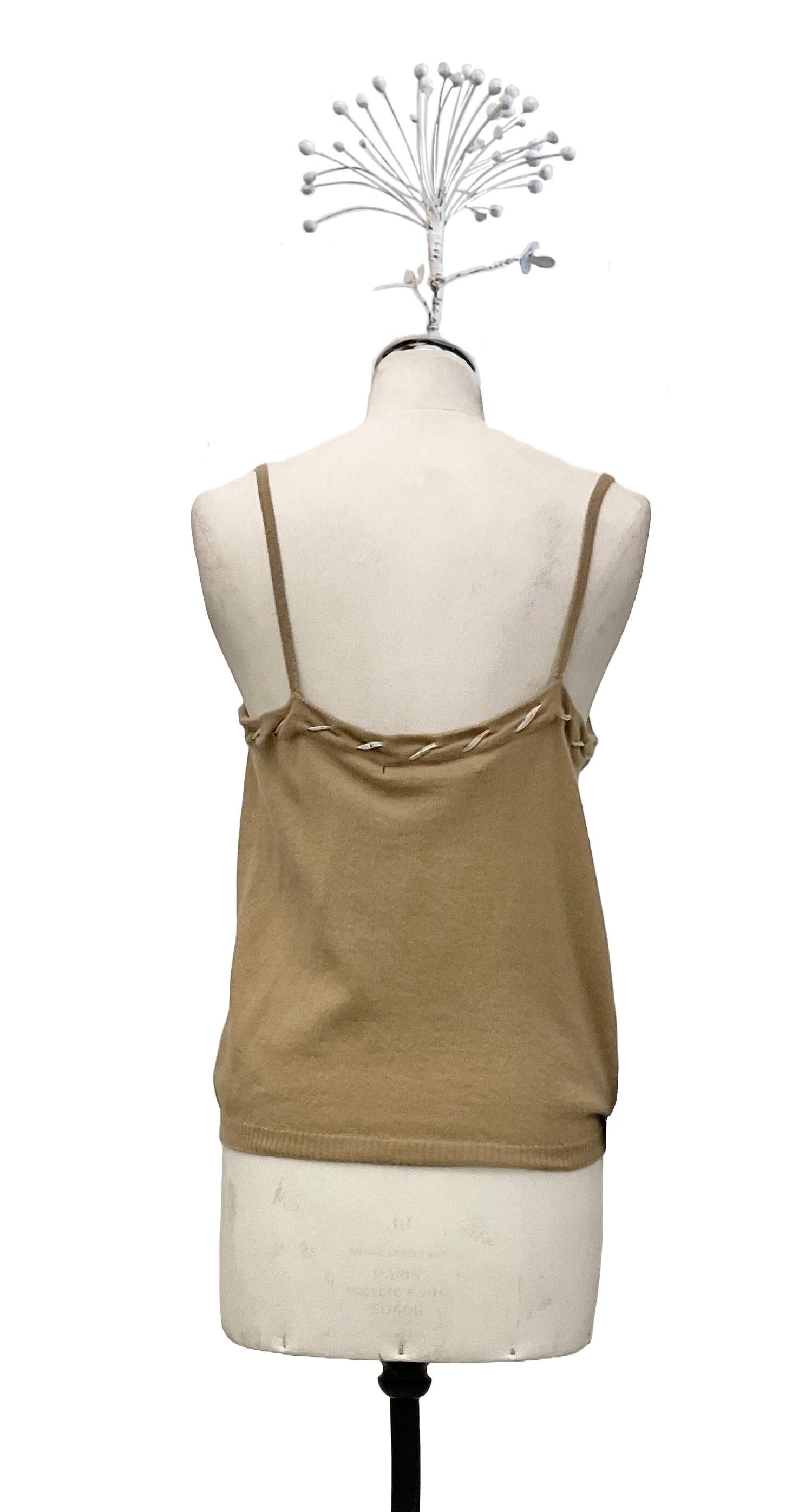 Wool knit top - angora by John Galliano from the collection
Ready to Wear Fall Winter 2005.
The top has a slip neckline and thin straps.
A printed silk organza ribbon decorates the neckline.
The color is beige and the composition is 70% wool and 30%