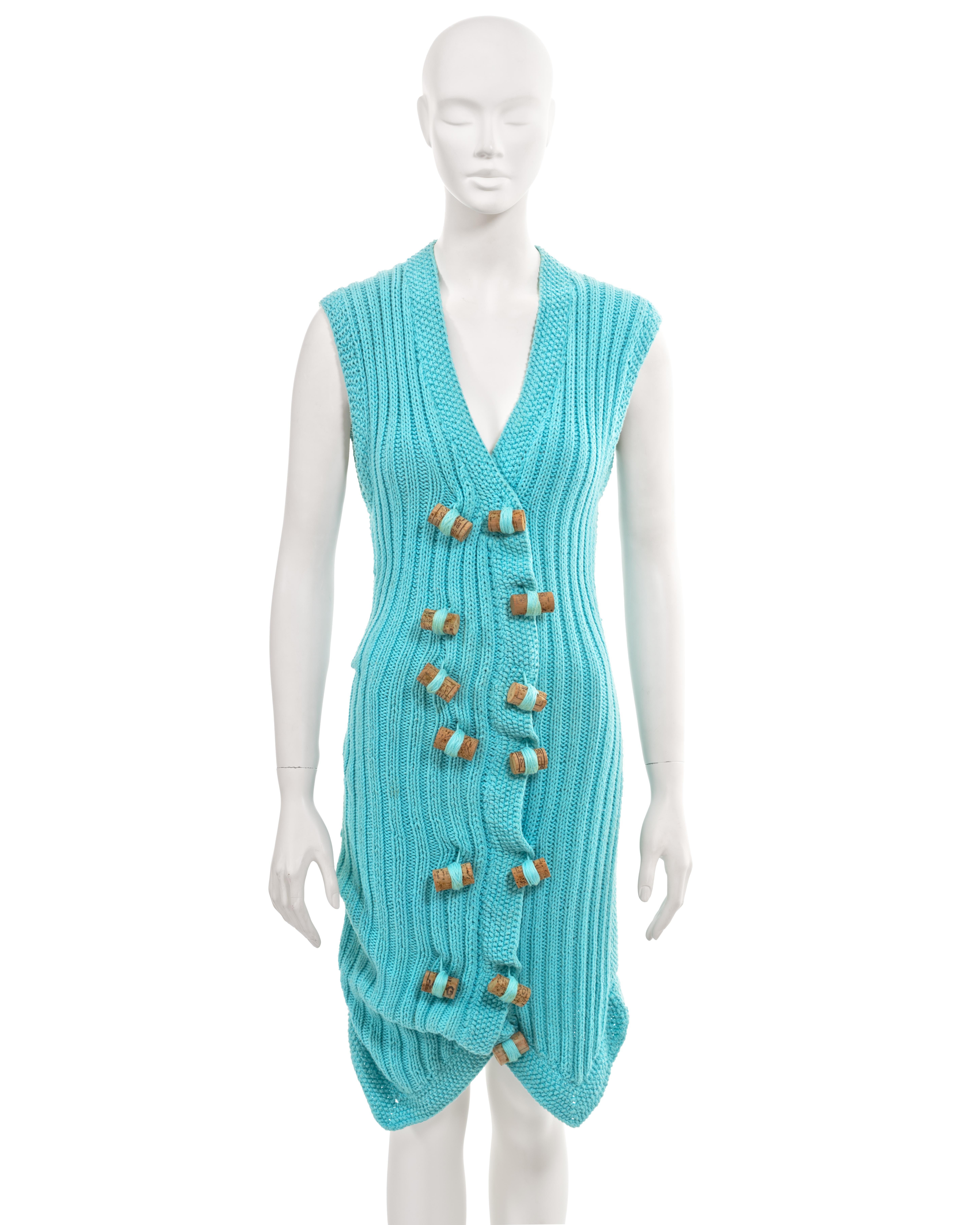 ▪ Archival John Galliano knitted dress
▪ 'The Ludic Game', Fall-Winter 1985
▪ Museum Grade
▪ Hand-knitted using turquoise cotton
▪ The front showcases a ribbed texture
▪ The back features a herringbone pattern
▪ Includes two functional pockets on