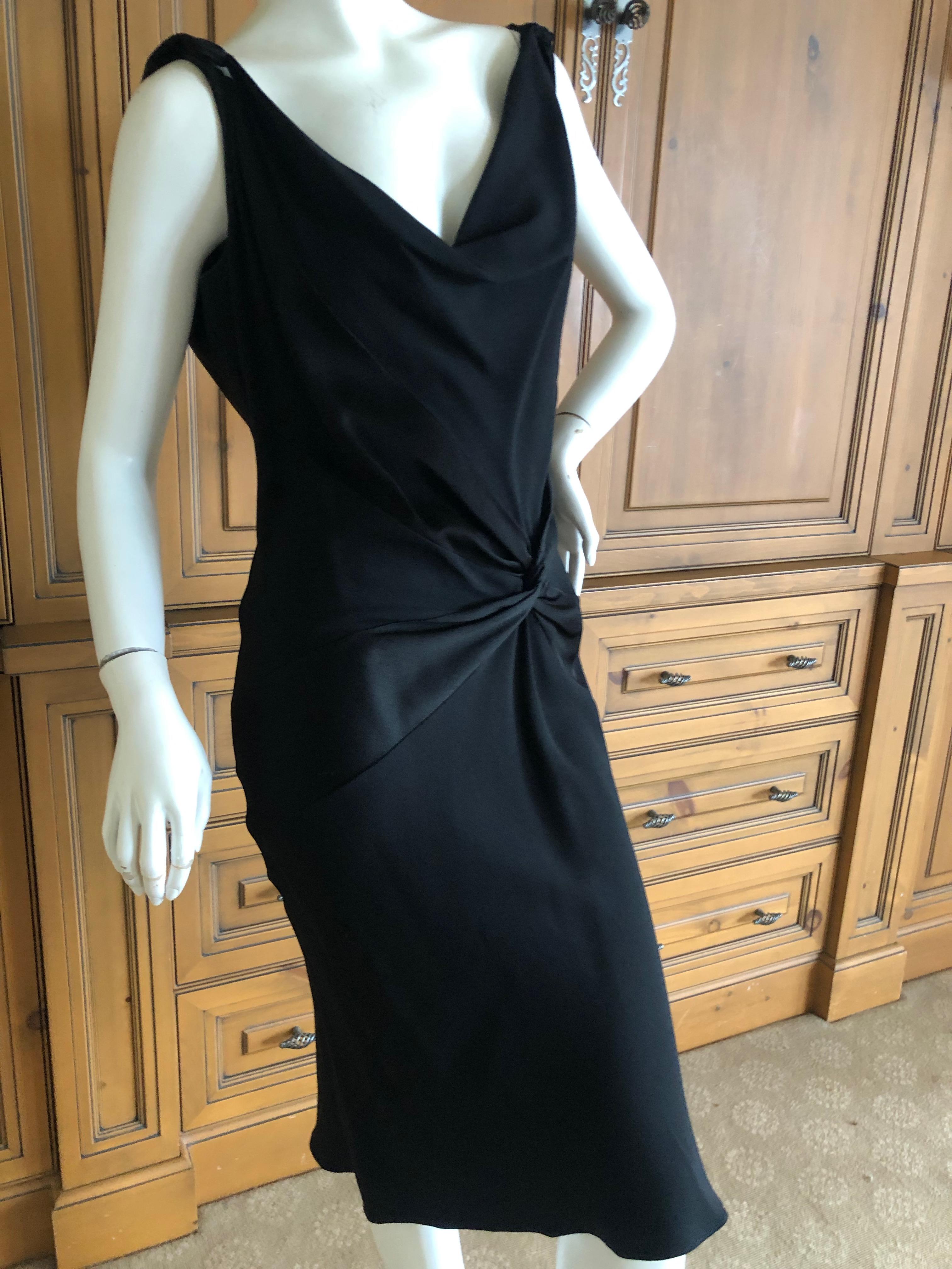 John Galliano Vintage 1990's Low Cut Black Shine and Matte Knot Dress.
This is signature Galliano, the knot motif is a repeated motif, as is his use of front and back of the fabric to create shine and matte contrasts, cut on the bias, will fit