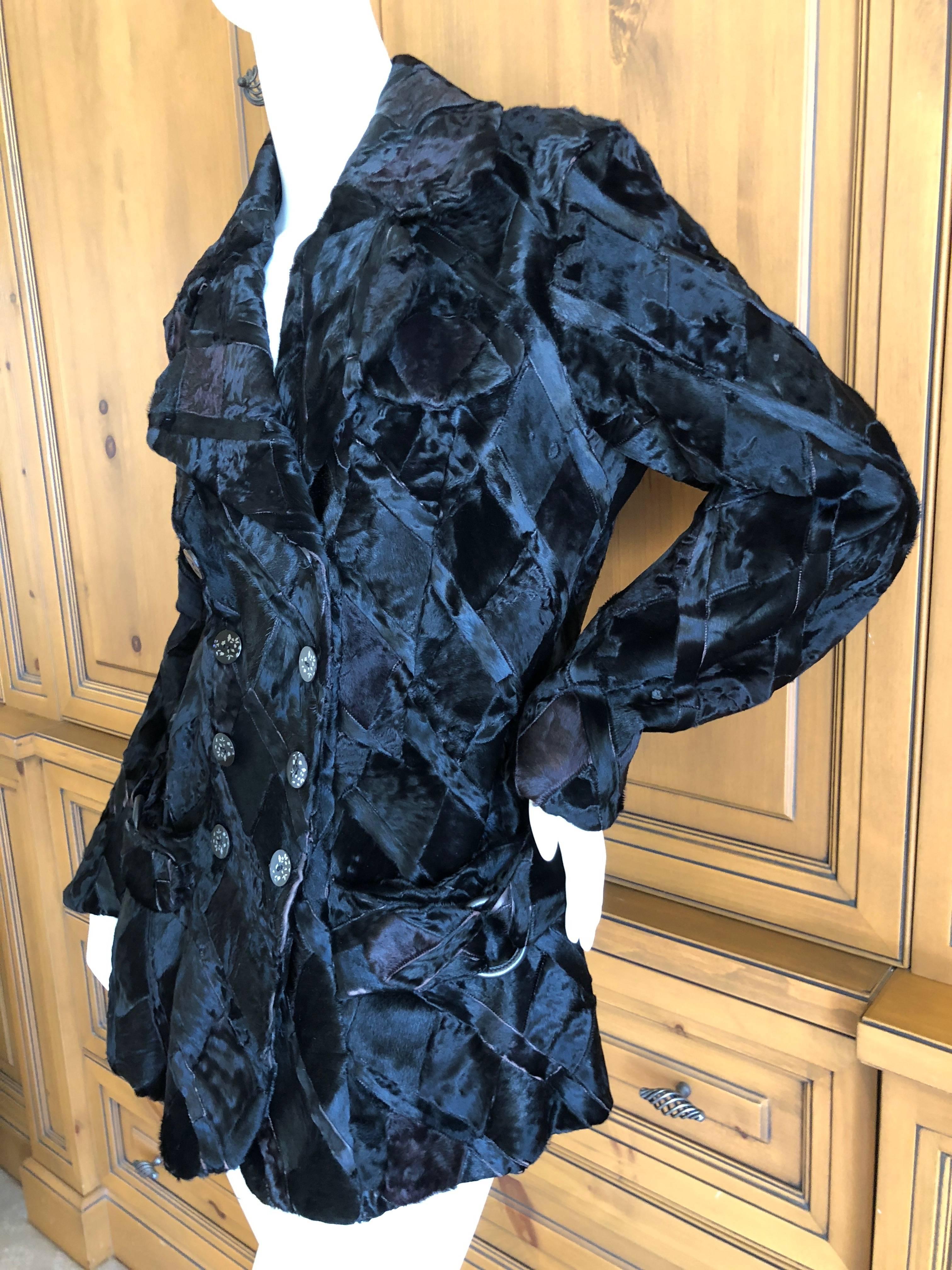 Exquisite black broadtail fur jacket from John Galliano , circa 1999.
Unusual diamond pattern with half belts attached.
Size 44
Bust 42