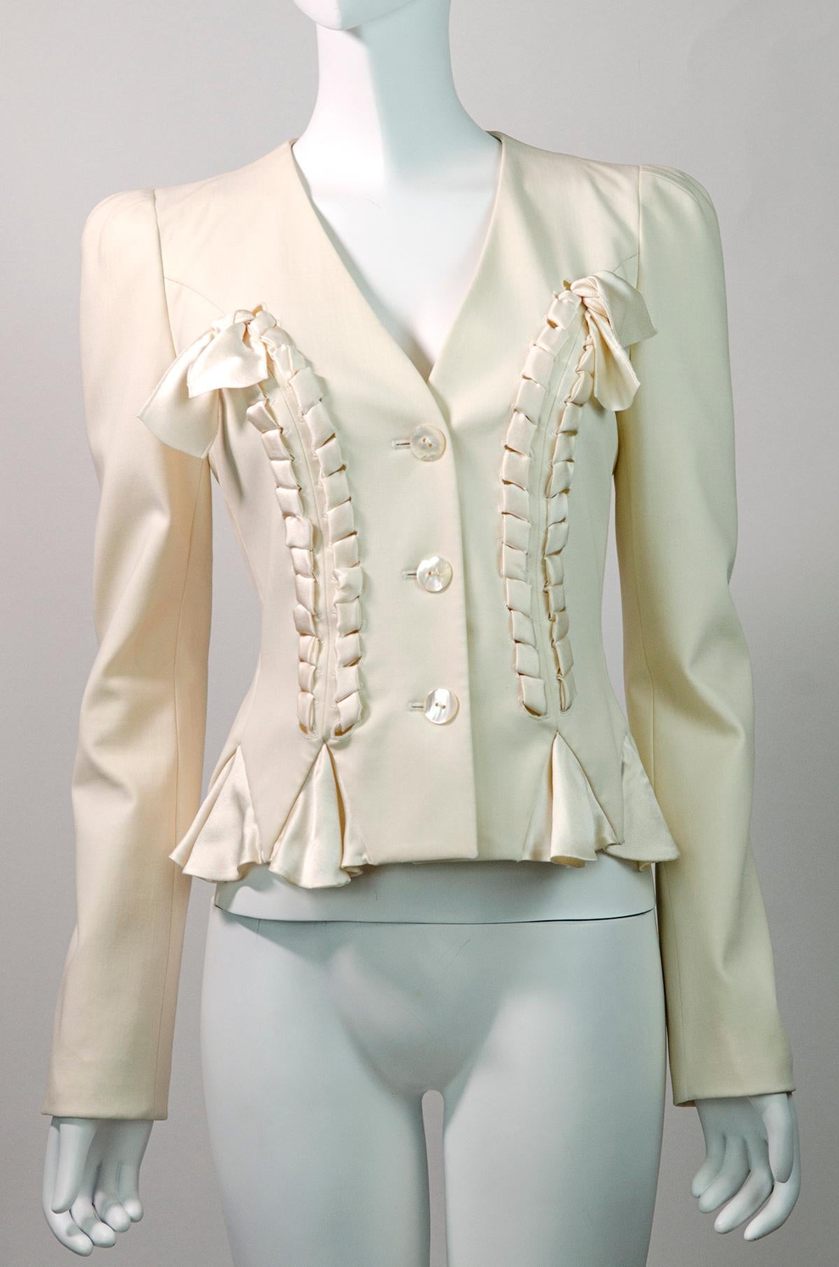 Beautiful feminine tailored blazer by John Galliano from the 2000s. Features a beautiful bow detail at the front. Very inspired by 1940s tailoring - it features peaked shoulders, long sleeves, a V shaped neckline and a peplum detail with silk