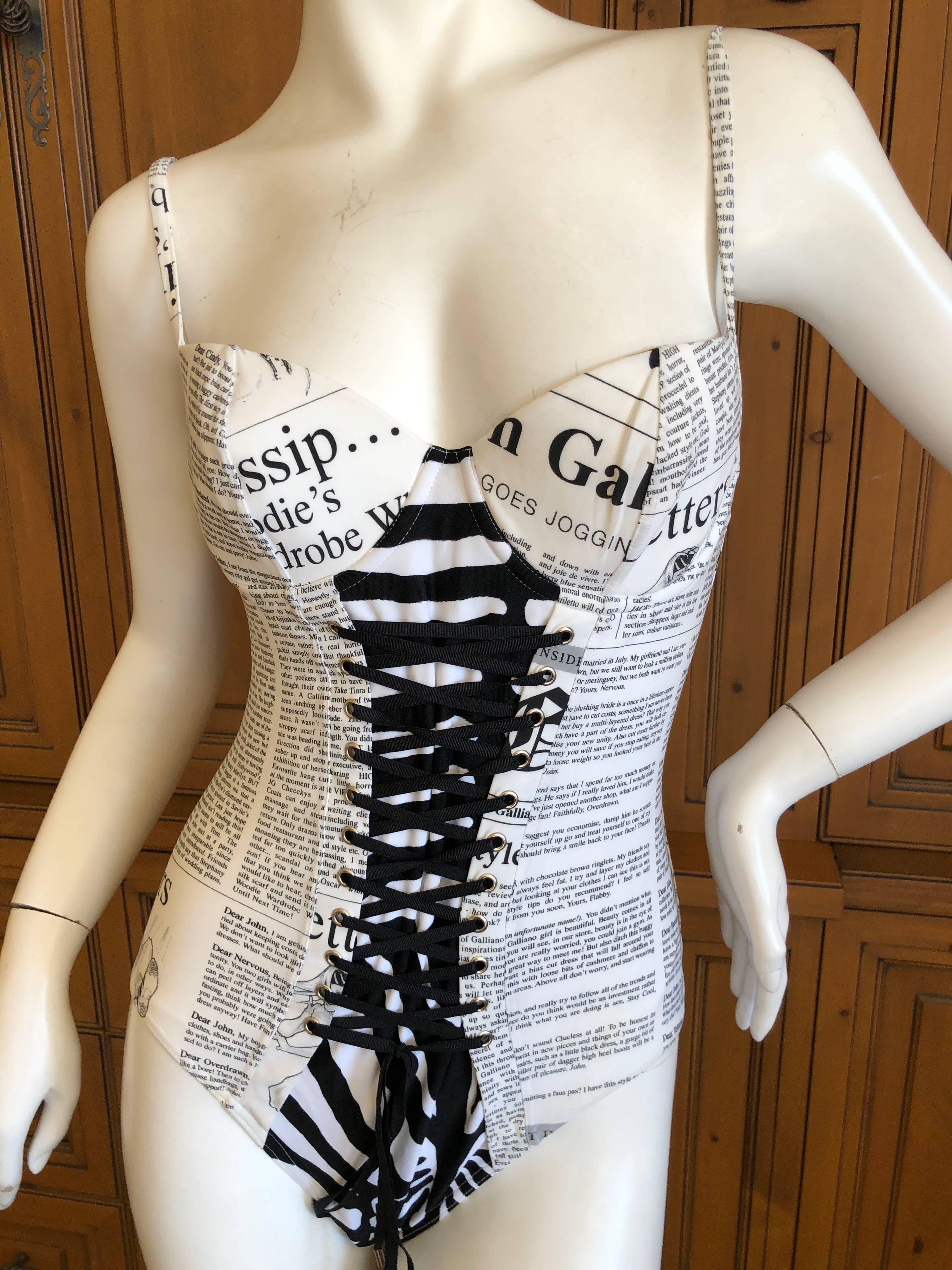 Wonderful one piece swimsuit from John Galliano.
Featuring newspaper with faux gossip stories about Galliano.
Zebra print and corset lace details  pure Galliano.
This has a very slight yellowing all  over, I believe it is intentional , to make the