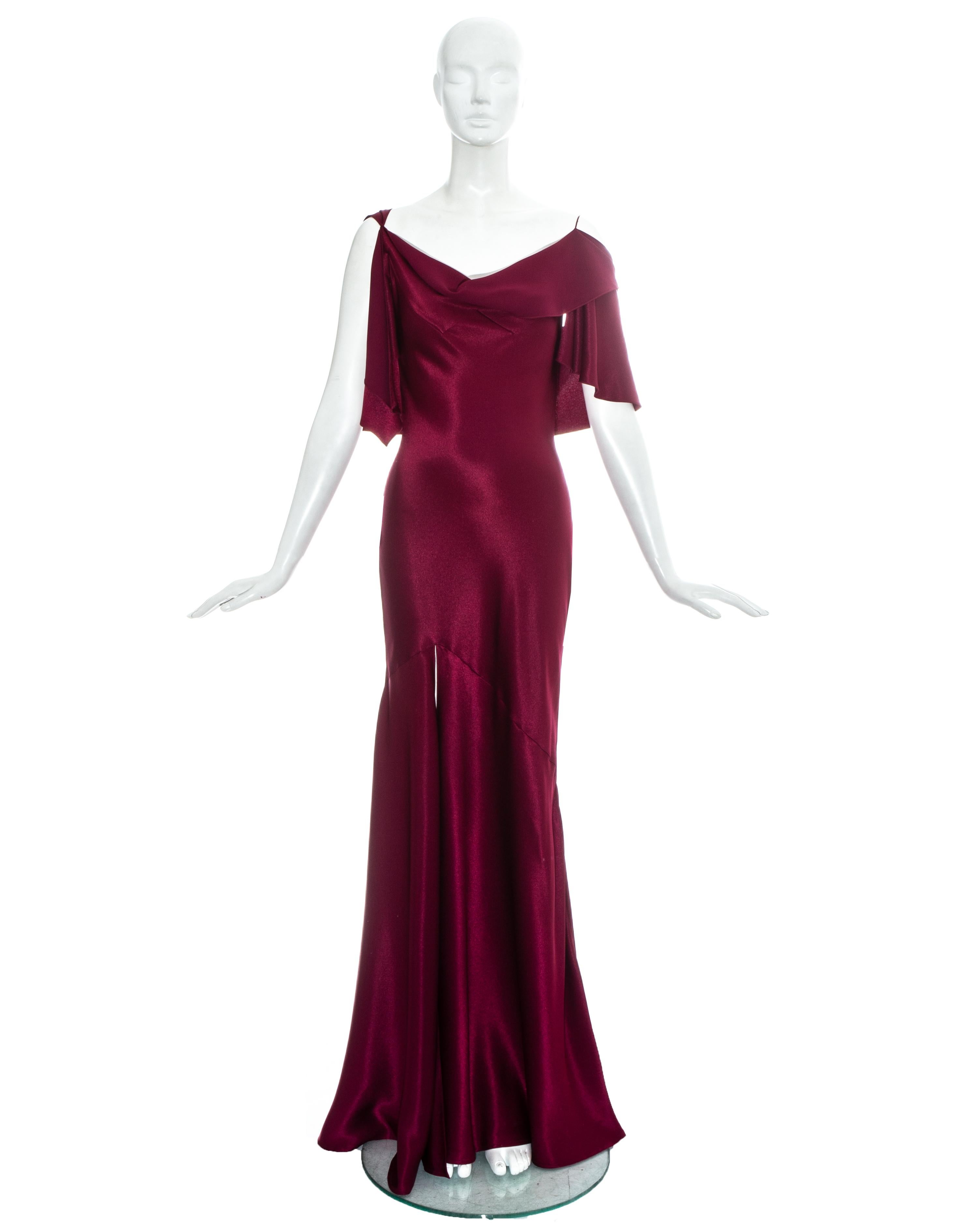 John Galliano wine red satin bias cut evening dress with attached caplet and high leg slit.

Fall-Winter 1999