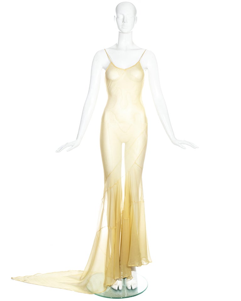 John Galliano yellow silk chiffon bias-cut slip-dress with plunging back, spaghetti straps and pointed trained hem.

'Filibustiers' collection, Spring-Summer 1993

