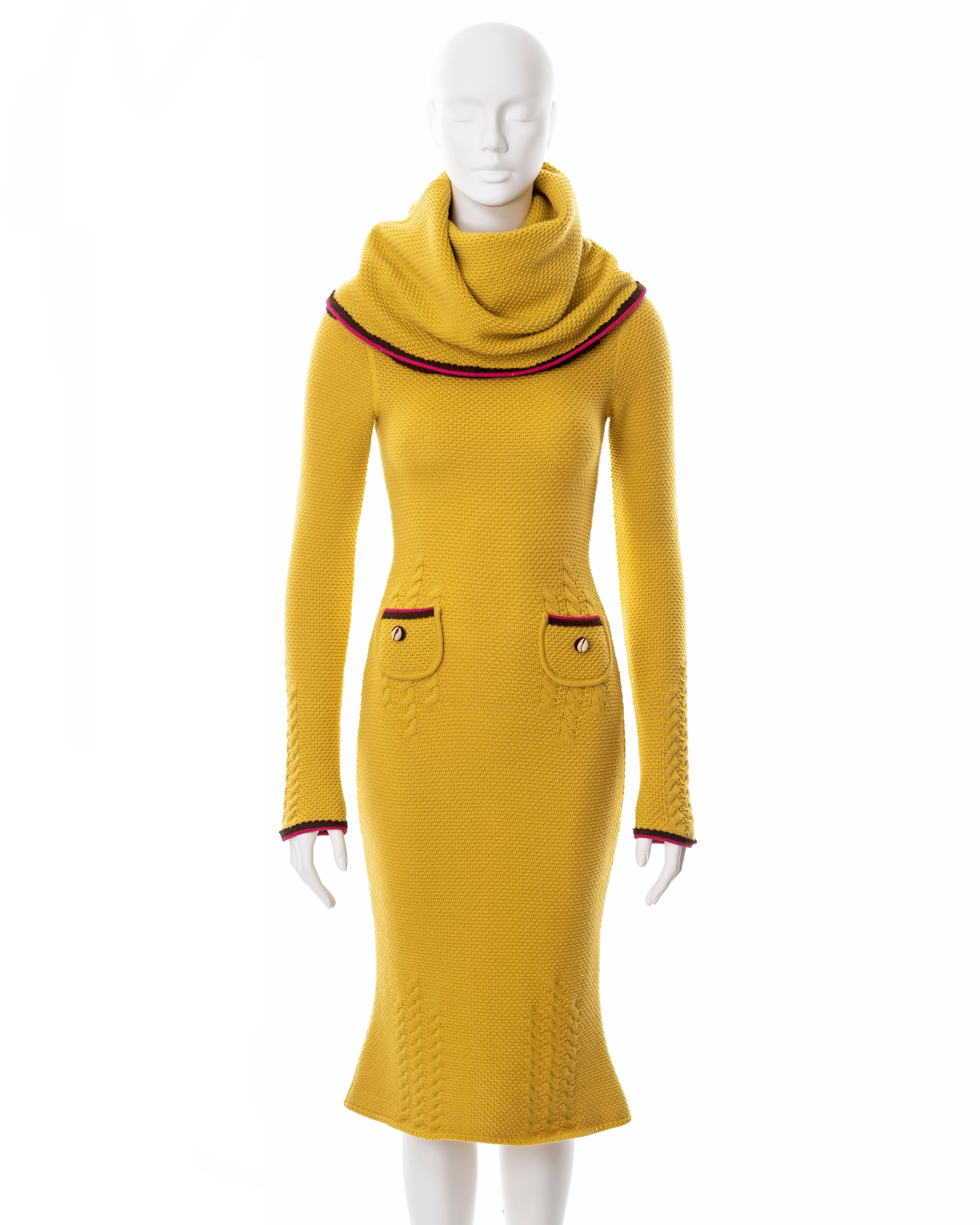 ▪ John Galliano yellow waffle-knit long sleeve dress
▪ Fall-Winter 1999
▪ Outsized turtleneck doubles as a hood
▪ Waffle-knit and cable-knit combination  
▪ Burgundy and pink felt scalloped-edged trim
▪ 2 small front pockets with Cowrie shell