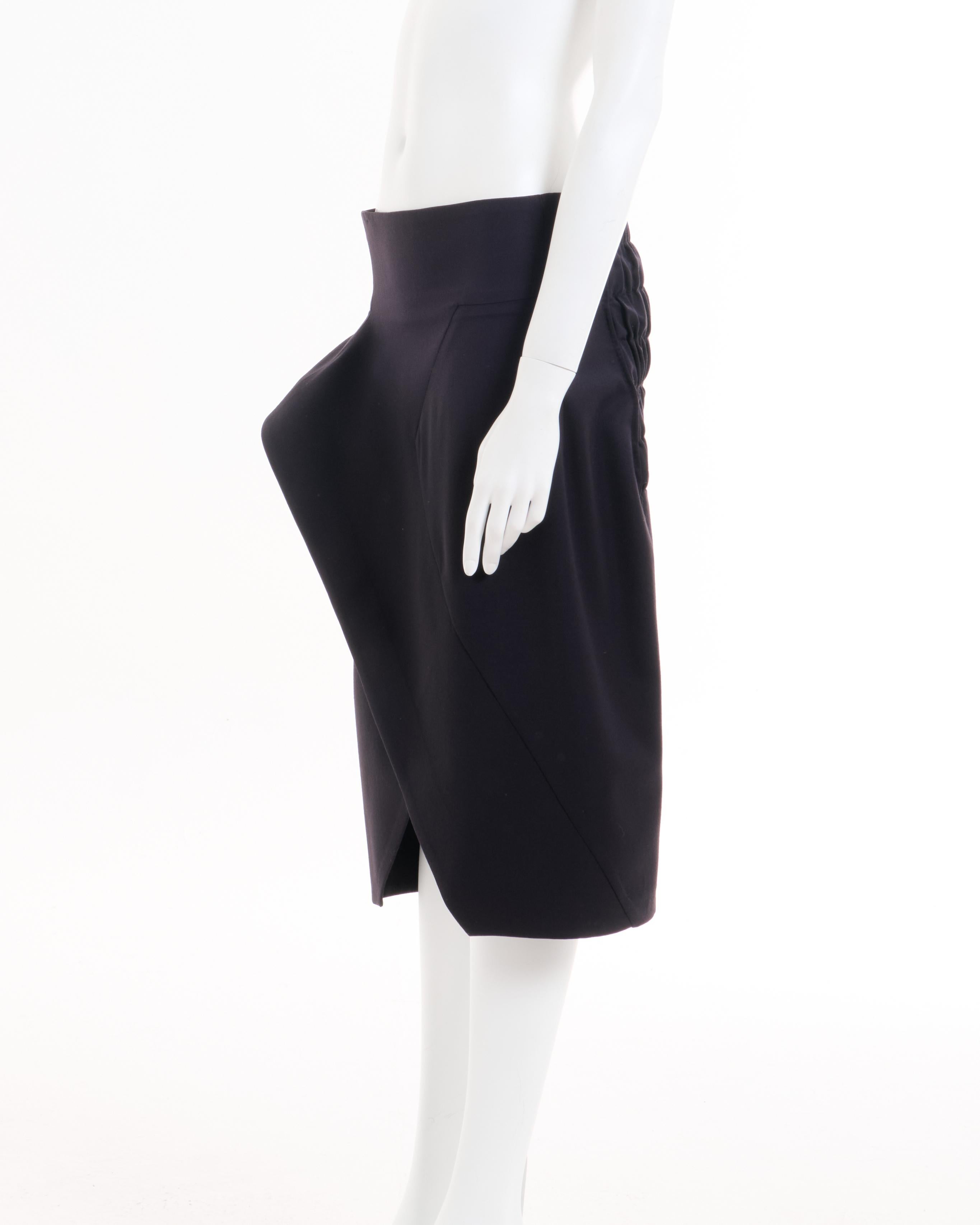 - John Galliano Plum wool overlapped asymmetric skirt
- Fall-Winter 1986 ‘Fallen Angels’ Collection
- Hight waist 
- Internal bones on waistline to hold-up and also on the external hem to keep the fold-up
- Back elasticated gathering 
- Draped