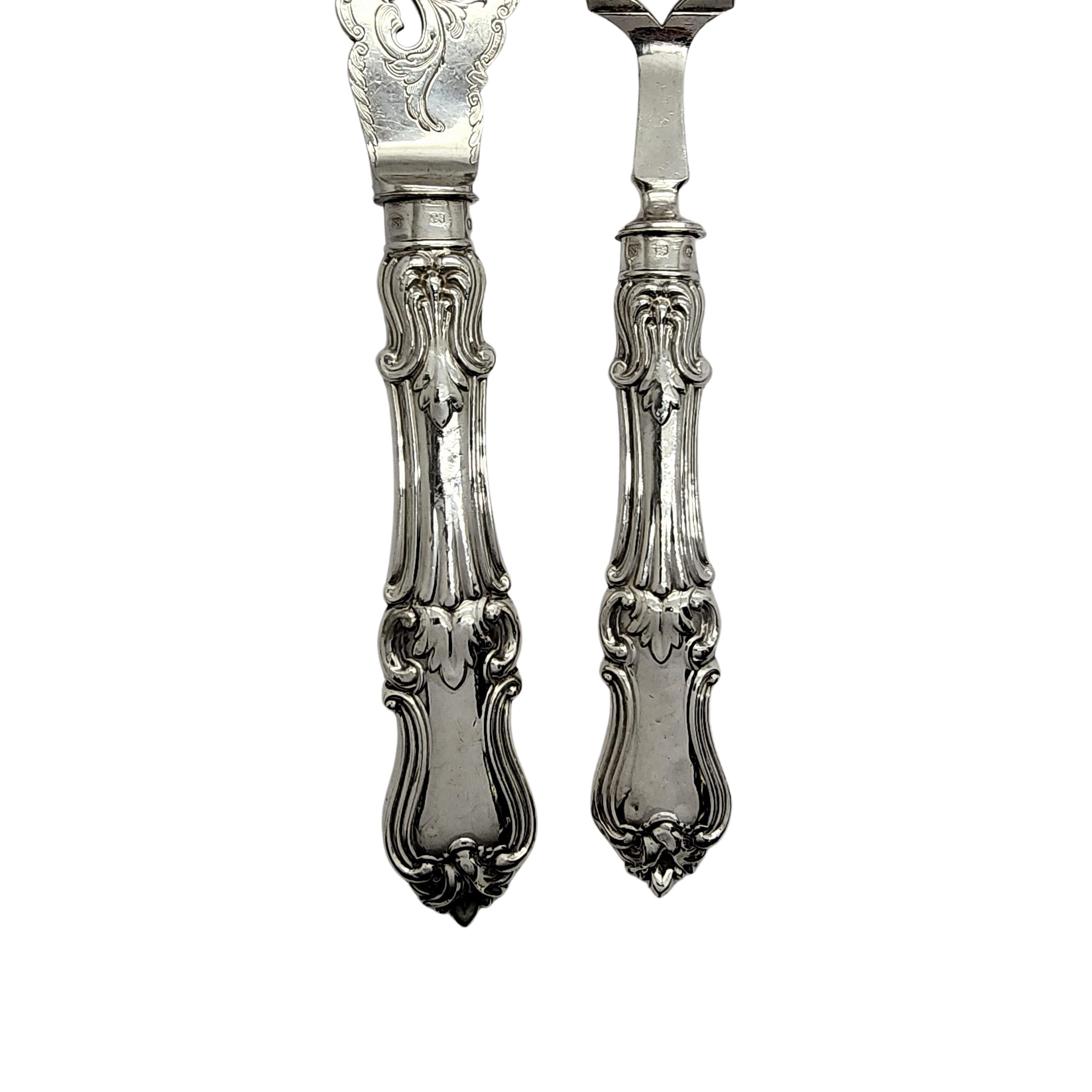 Antique sterling silver fish fork and knife serving set by John Gilbert of England, circa 1858.

No monogram

This beautifully ornate serving set are all sterling silver, both pieces feature open work and etched brite-cut design. There is also an
