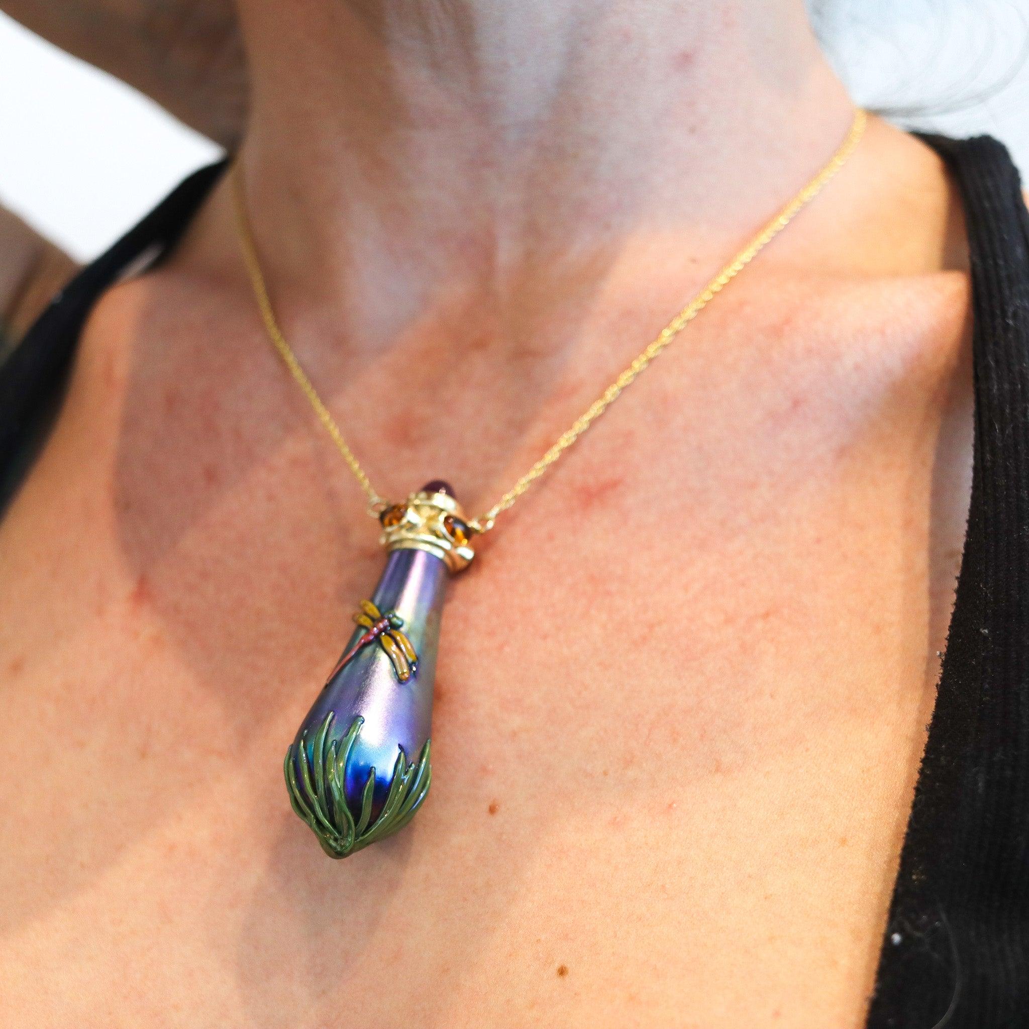 Art glass perfume bottle necklace designed by John Gilvey.

This is an amazing art-glass perfume bottle necklace created in New York by the studio artists John & Wendy Gilvey for Hudson Beach Glass studio, back in the 1990. The bottle itself if made