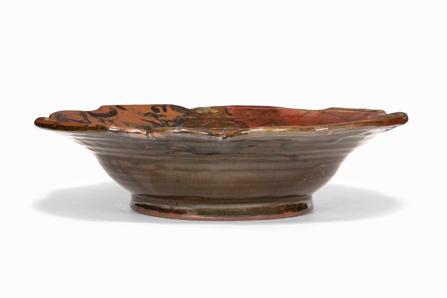 The ceramic bowl is an example of the kind of work by which John Glick became so famous. He was seduced by the effects of the reduction kiln, which decreased the levels of oxygen during firing, inducing the flame to pull oxygen out of the clay and