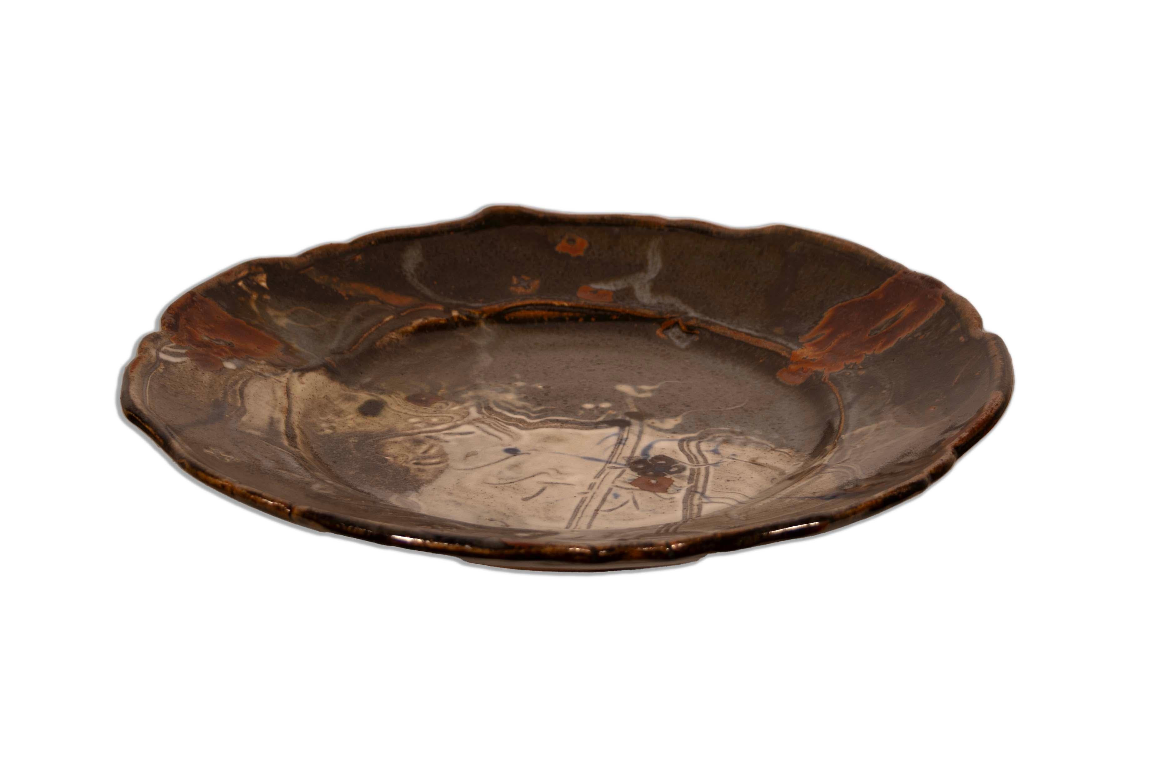  Discover this captivating Mid Century Modern Plum Tree Charger Plate by the renowned potter John Glick. This artistic ceramic plate is a conversation piece, featuring a harmonious blend of earthy tones, subtle textures, and an organic, flowing
