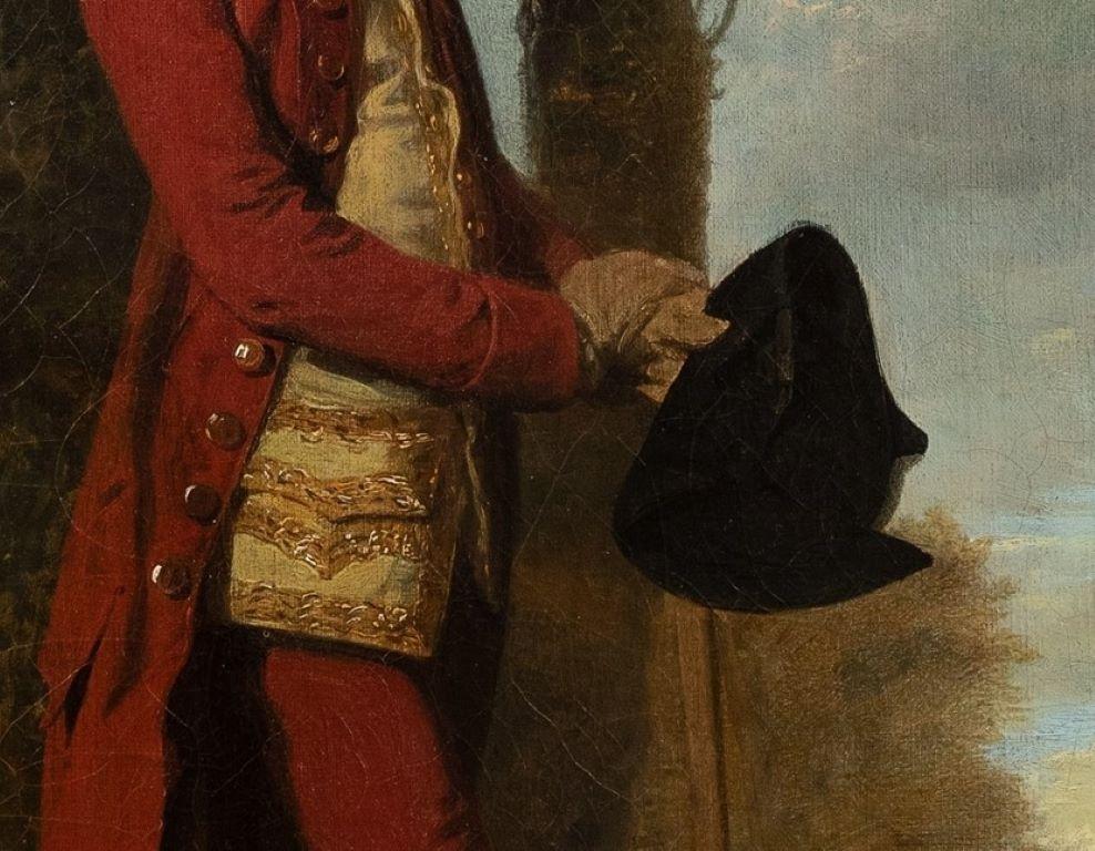 Porträt von James Stanley (1750 - 1810), um 1775-1778, ganzfigurig, in rotem Mantel und Hose sowie goldbestickter Weste, den Hut in der Hand haltend und sich auf seinen Stock stützend unter einem Baum in einer Waldparklandschaft.
Öl auf Leinwand in