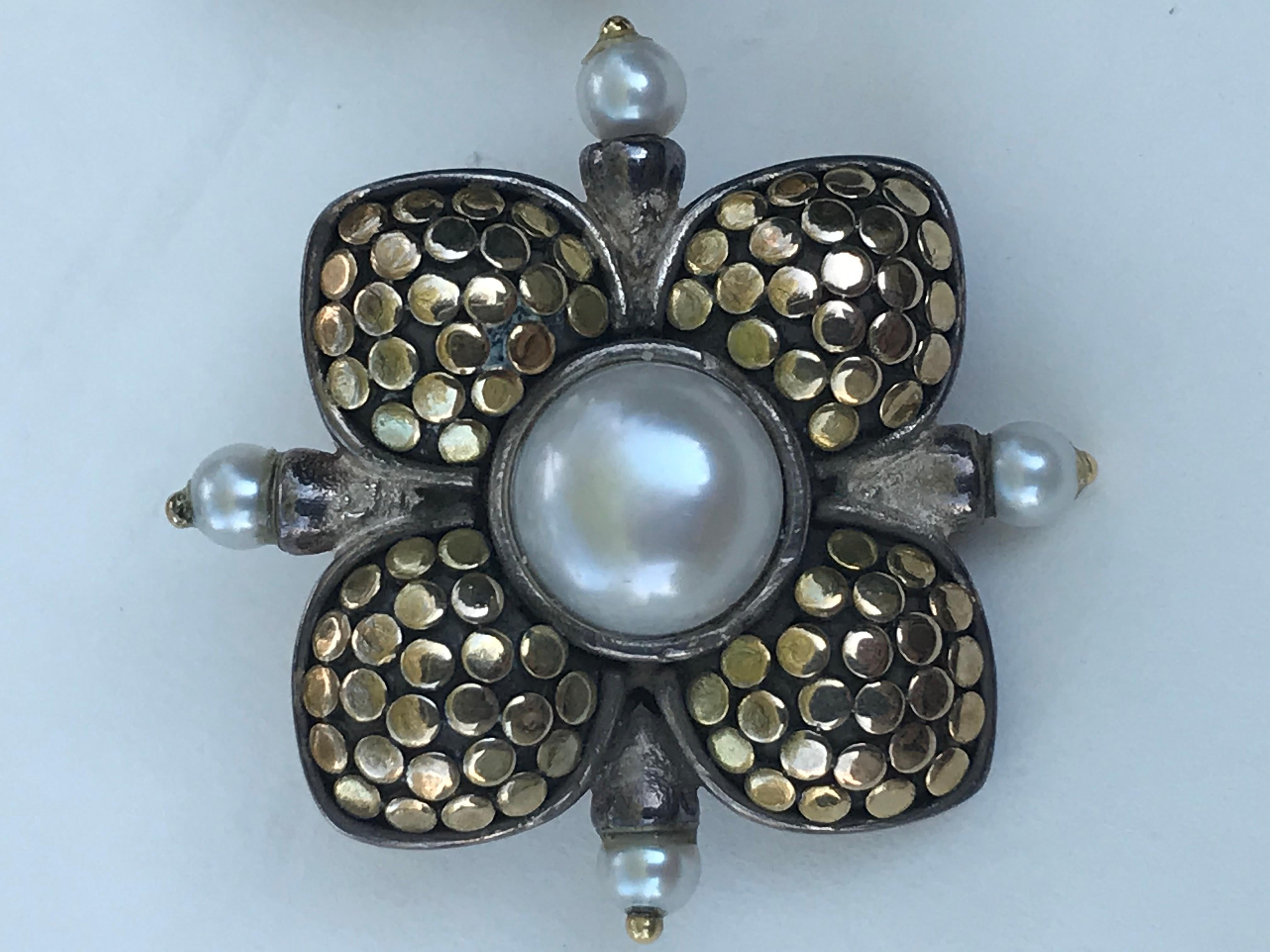These beautiful pearl earrings from John Hardy are an awesome addition to any jewelry box.
John Hardy
Sterling silver with 18 karat yellow gold accents in flower design
10 total pearls
2 center mabe pearls are approximately 8mm round
8 round small