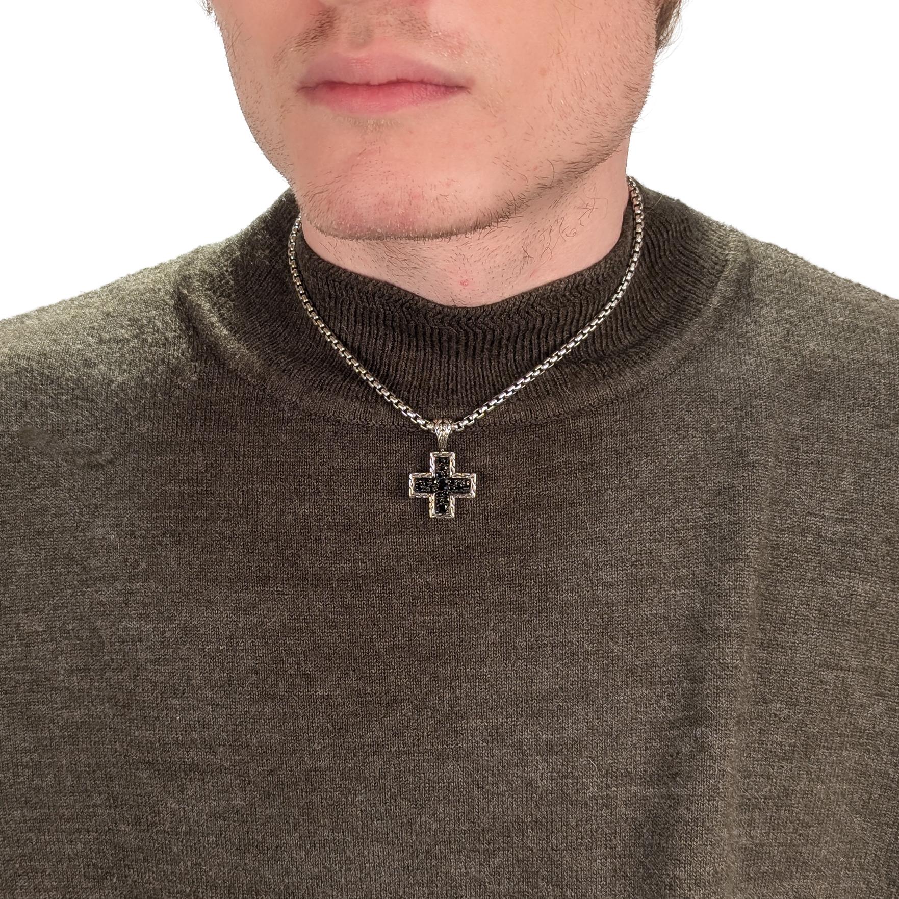 A fine signed cross pendant.

By John Hardy.

In sterling silver.

With pave set round and oval black sapphires on the front and engraved with a cable pattern to the sides, back, and integral bail.

Marked to the reverse.

Simply a wonderful John