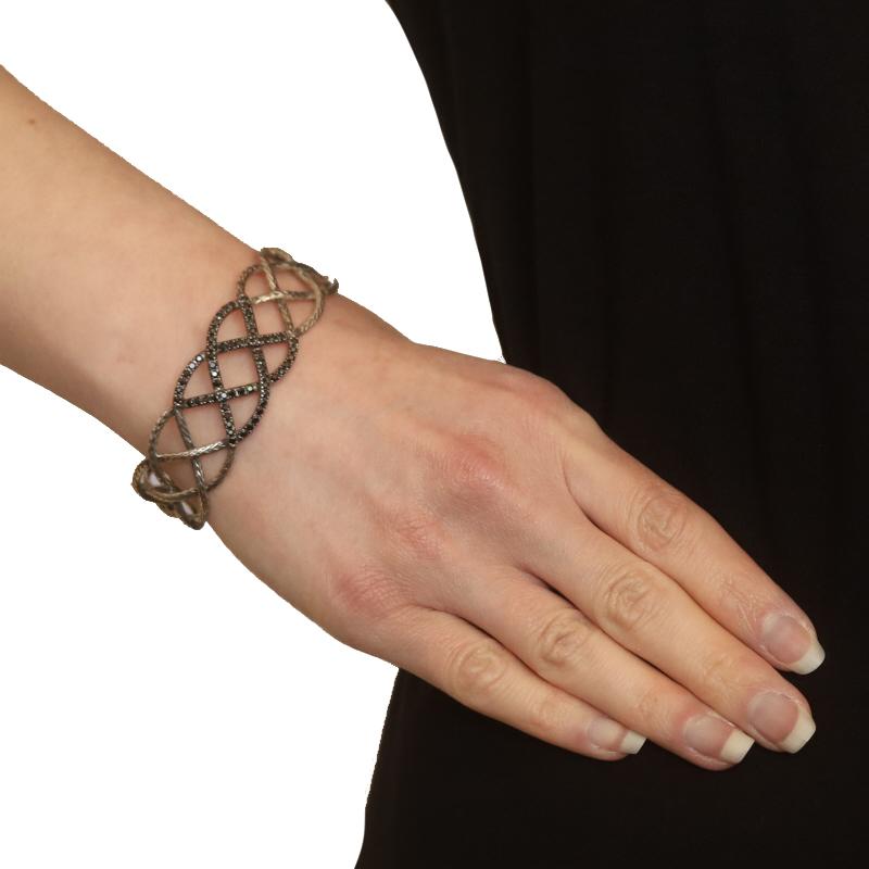 Retail Price: $950

Brand: John Hardy
Collection: Classic Chain
Design: Braided Cuff

Metal Content: Sterling Silver

Stone Information
Natural Black Sapphires
Treatment: Heating
Cut: Round

Style: Cuff
Fastening Type: N/A (slides over