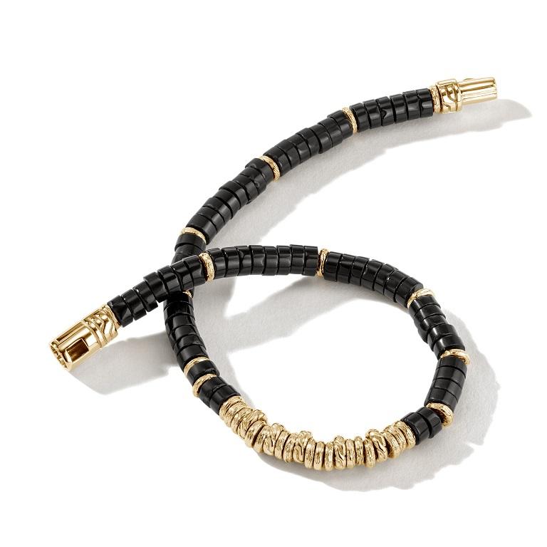 This Heishi Bracelet by John Hardy Features beautiful Onyx beads separated by shiny 14K Yellow Gold beads. The 4mm guage bracelet is help together by a Gold pusher clasp.

Color: Black
Bracelet: 1 band
Material: Gold
Metal Stamp: 14k
Model: