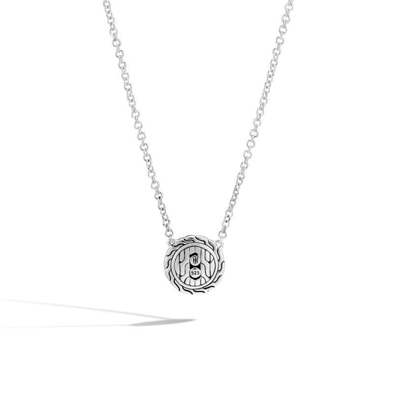 The John Hardy Classic Chain Silver Round Black Gemstone Pendant Necklace is an alluring piece that unites traditional Balinese craftsmanship with contemporary elegance. The focal point of this necklace is a striking round black gemstone pendant,