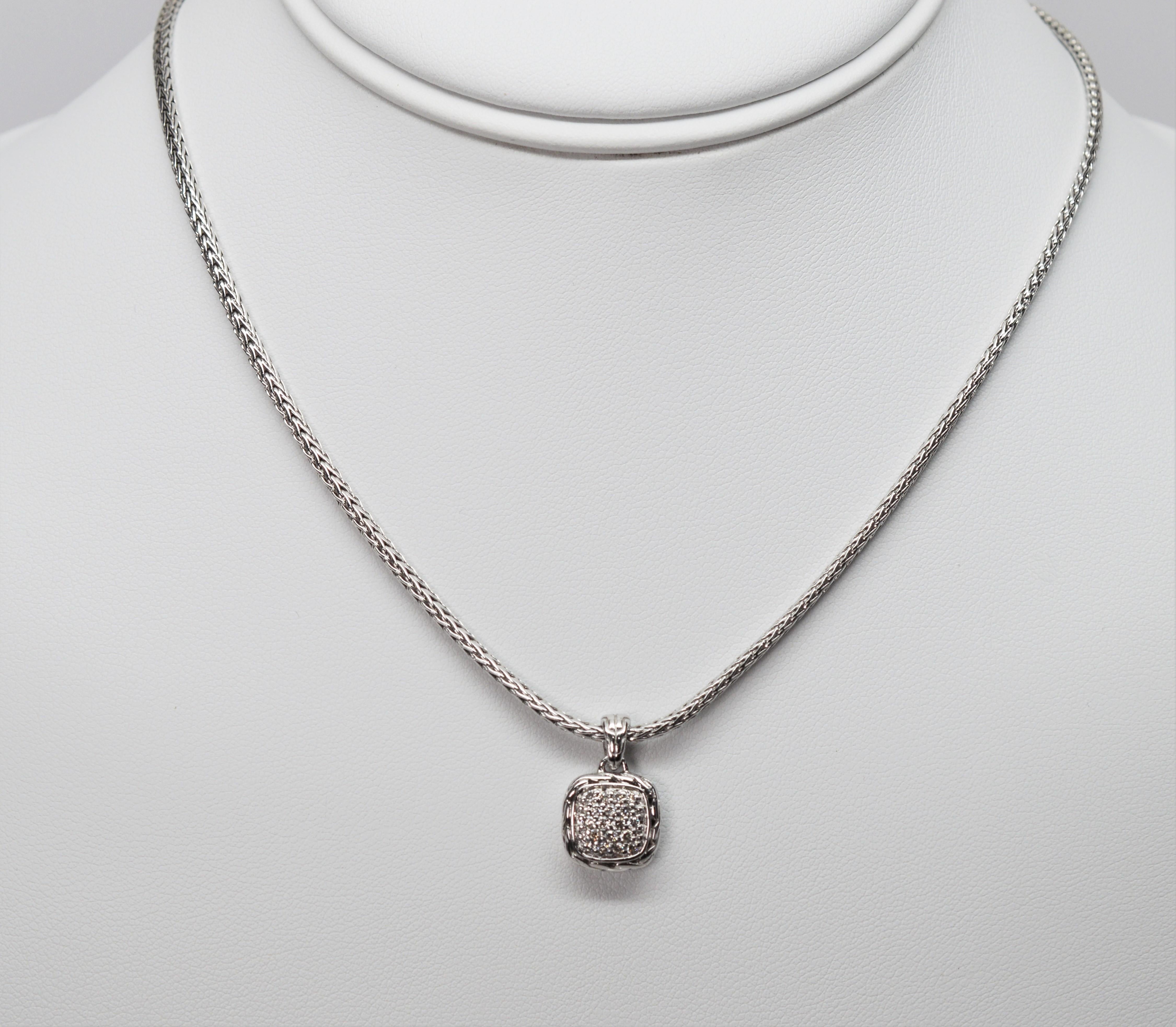 Artisan crafted in sterling silver, with a dramatic woven chain design, this John Hardy classic pendant necklace hosts an eye catching pave white diamond pendant measuring 11 mm x 19.5 mm ( 1/2  x 3/4 inch) including the bale. Finished with a