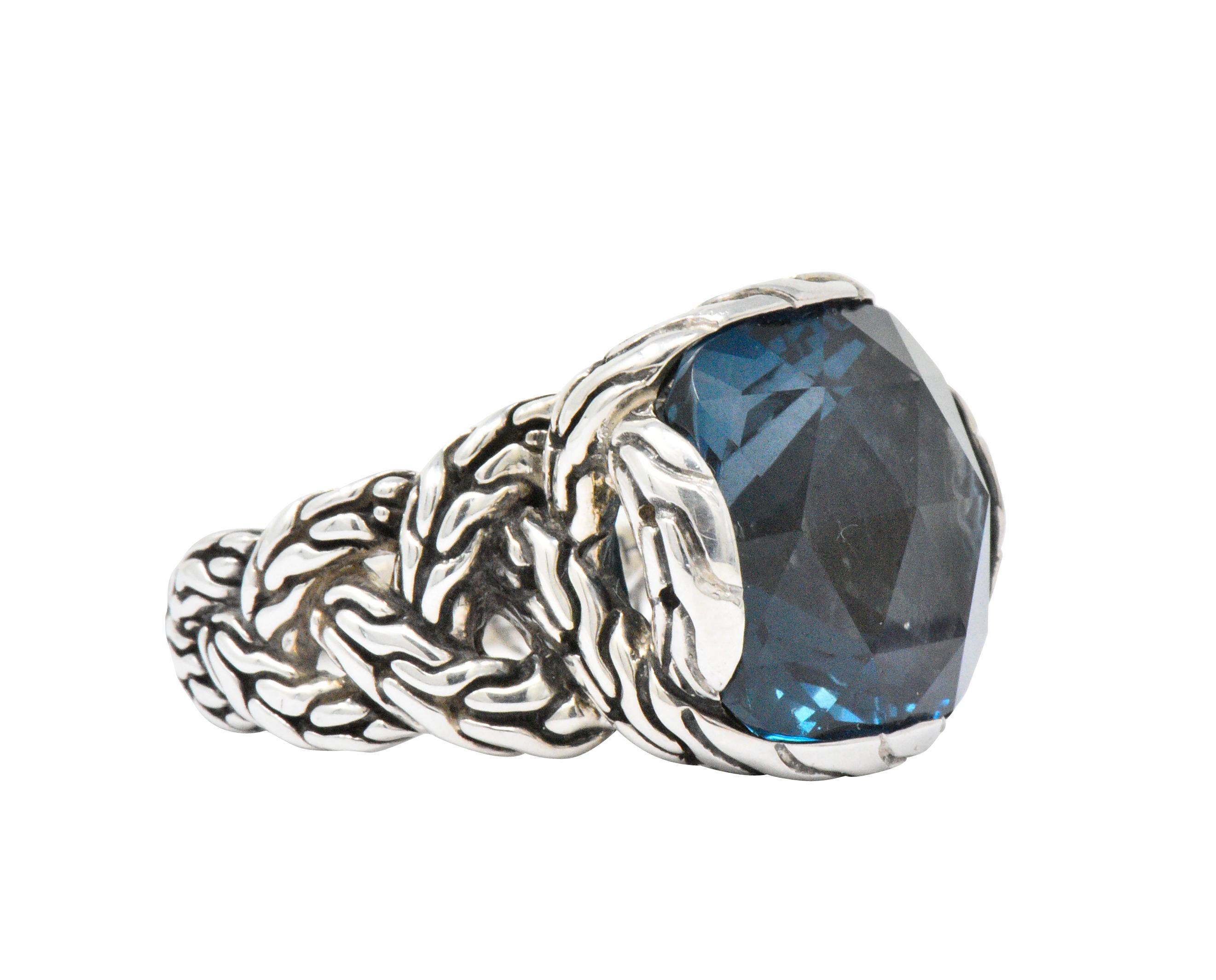 Centering a cushion cut and bezel set London blue topaz, deep vivid blue 

Securely bezel set in classic John Hardy chain style mount

Chain motif continuing along sides of shank

Signed Hardy 925 with makers mark

New with original tags

Top
