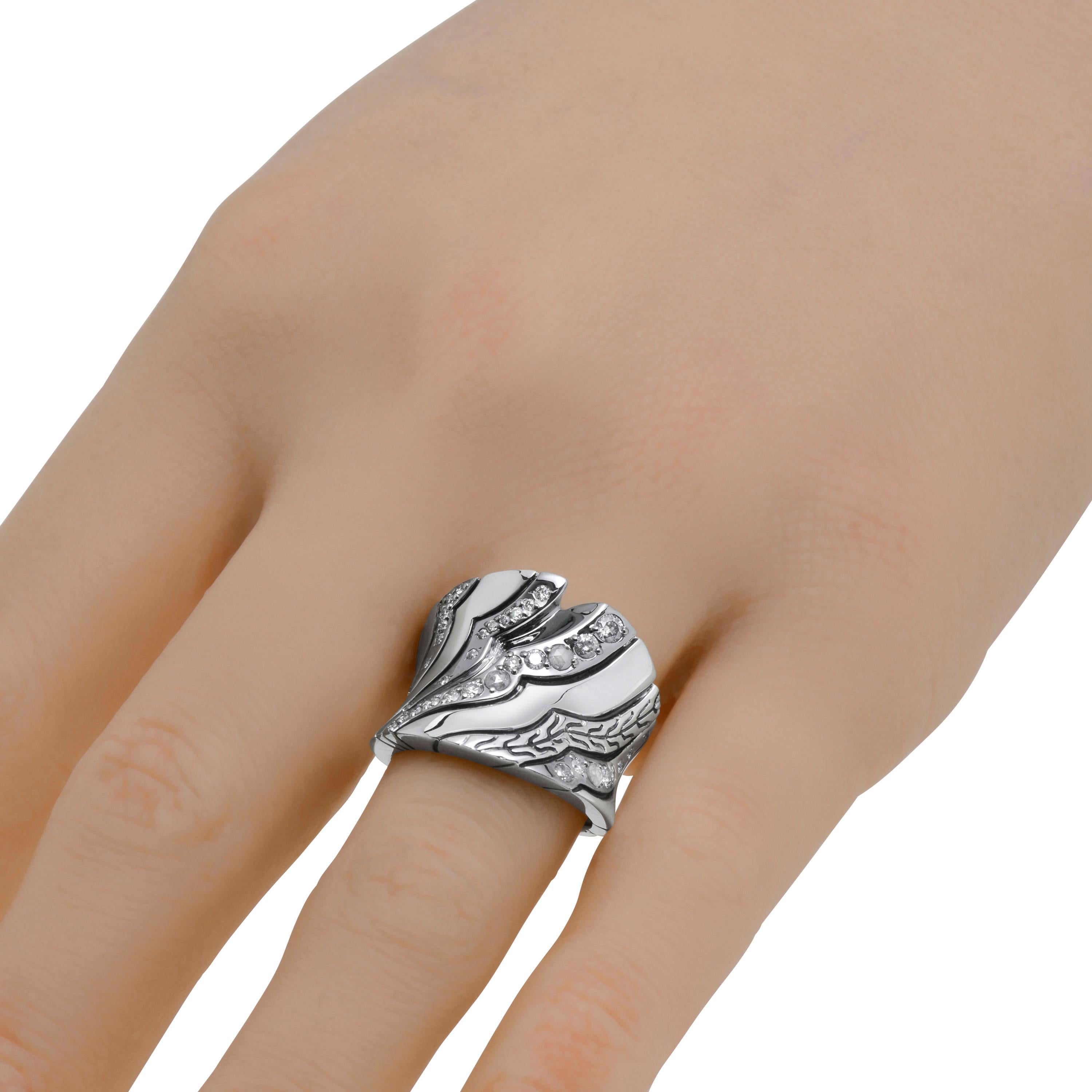 This captivating John Hardy Sterling Silver Saddle Ring features waves of shimmering white diamonds 0.10ct. tw. and Grey diamond pave 0.41ct. tw. accenting a sterling silver band with John Hardy classic chain engravings. Primarily inspired by