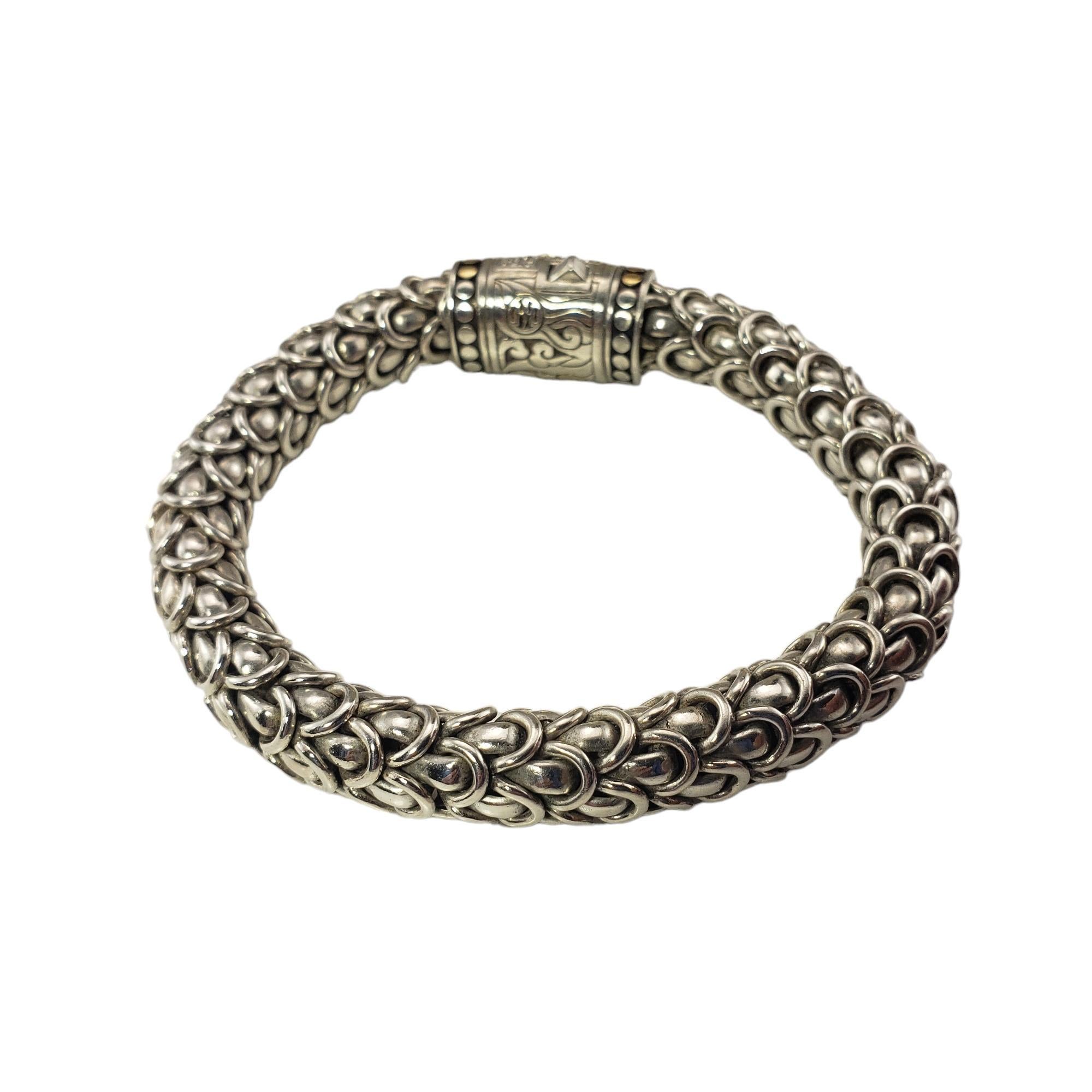 John Hardy Legends Naga Sterling Silver/18K Yellow Gold and Diamond Bracelet-

This elegant John Hardy bracelet is crafted in beautifully detailed sterling silver and 18K yellow gold and accented with sparkling pave set diamonds.  
Width: 10.5