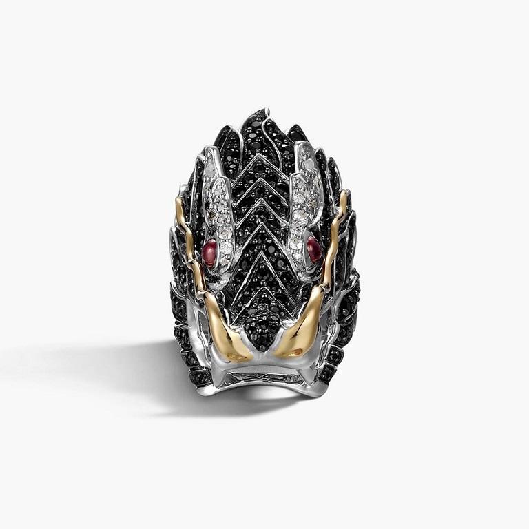 Ablaze with gemstones, this John Hardy ring from the Naga collection is amazing! Handcrafted with startling detail, sterling silver is used to form a dragon's head on a band. Scintillating black sapphires adorn the dragon's face. African rubies