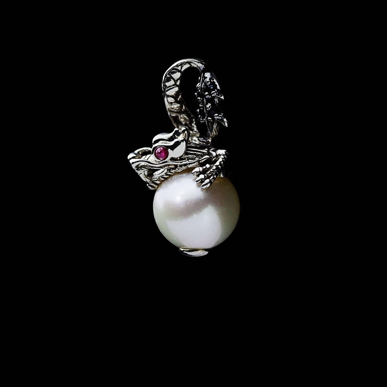 Each piece of John Hardy jewelry has been crafted in Bali since 1975. John Hardy is dedicated to creating timeless one-of-a-kind pieces that are brilliantly alive.

This sterling silver pearl and ruby pendant is from John Hardy's Naga collection.