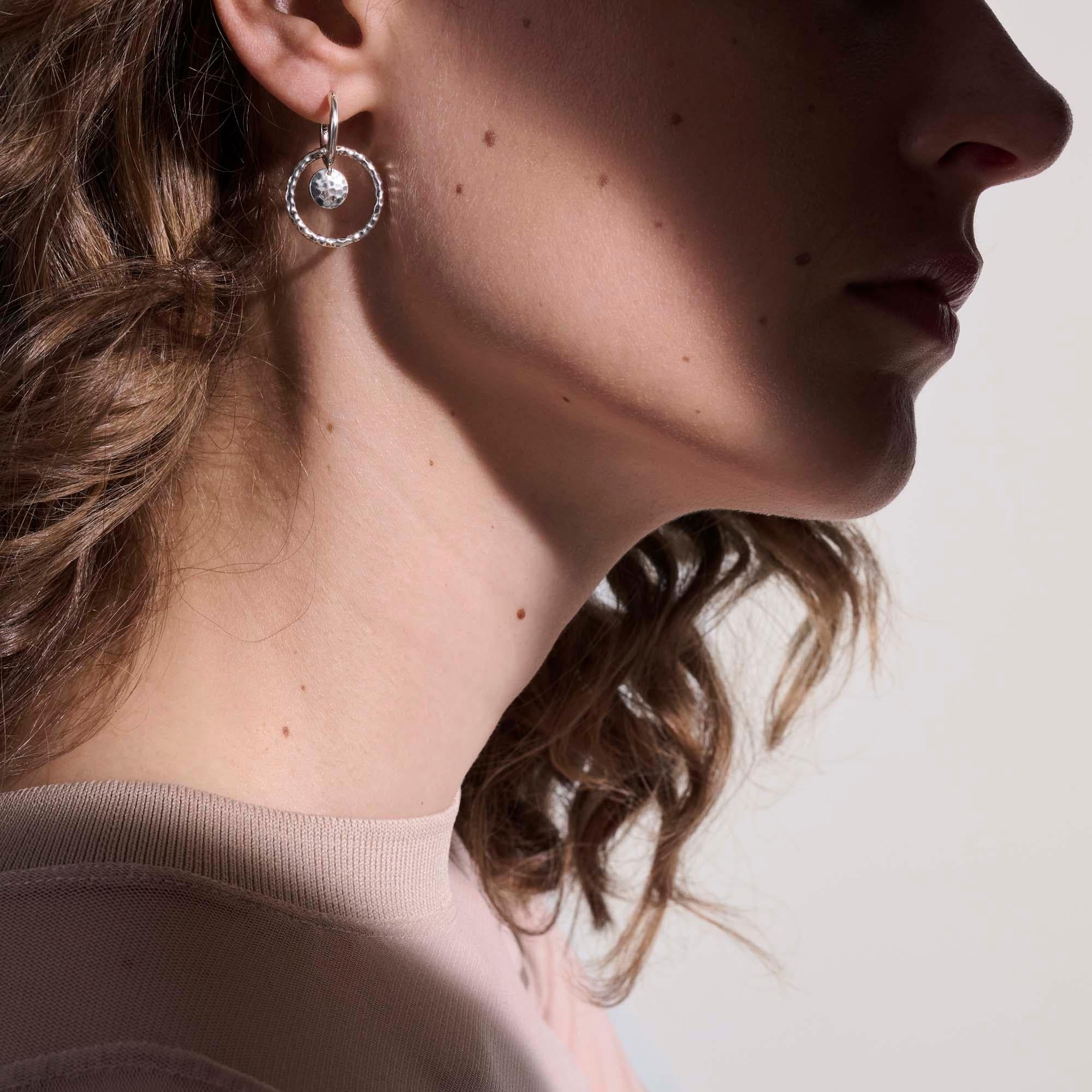 The John Hardy Dot motif is transformed into a hammered sterling-silver hoop that hangs from a smaller high-shine hoop. A round, hammered charm adorns the drop design for added texture and dimension. Drop Length is 30mm. 

Style No.: EB34000
Metal: