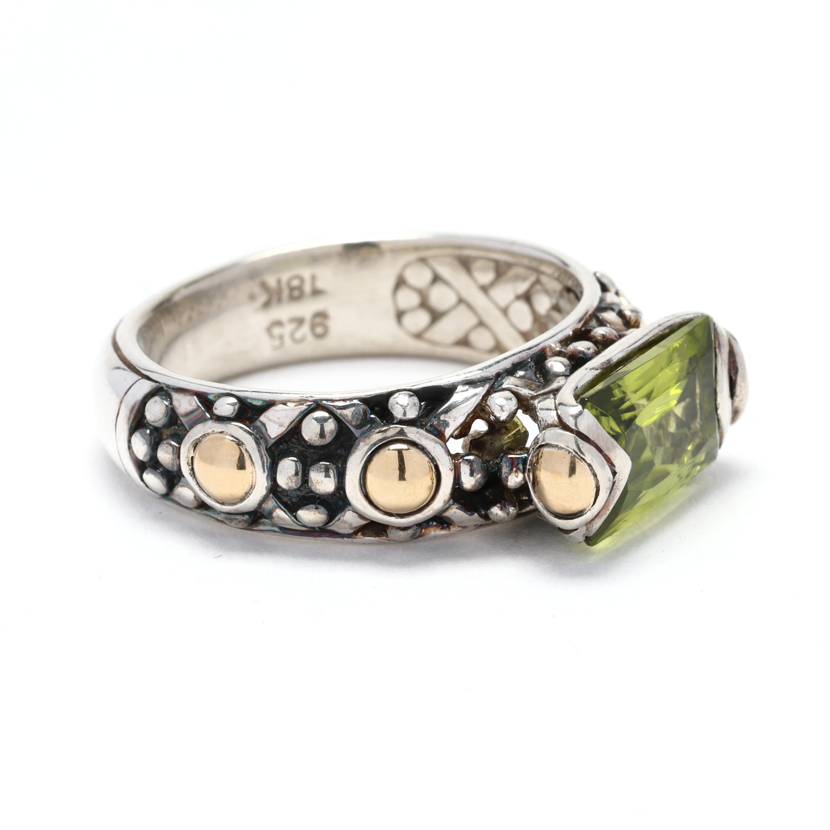 The John Hardy Peridot Band Ring is a captivating piece of jewelry that combines luxurious materials with unique design elements. Crafted in 18k yellow gold and sterling silver, this ring features a stunning peridot gemstone that adds a vibrant pop