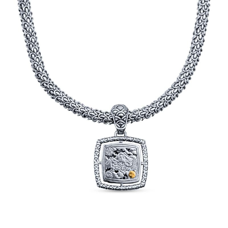 This necklace from John Hardy is crafted in sterling silver and features a pendant with 18 karat yellow gold dragon scale accents set on a decorative chain. The chain measures 18